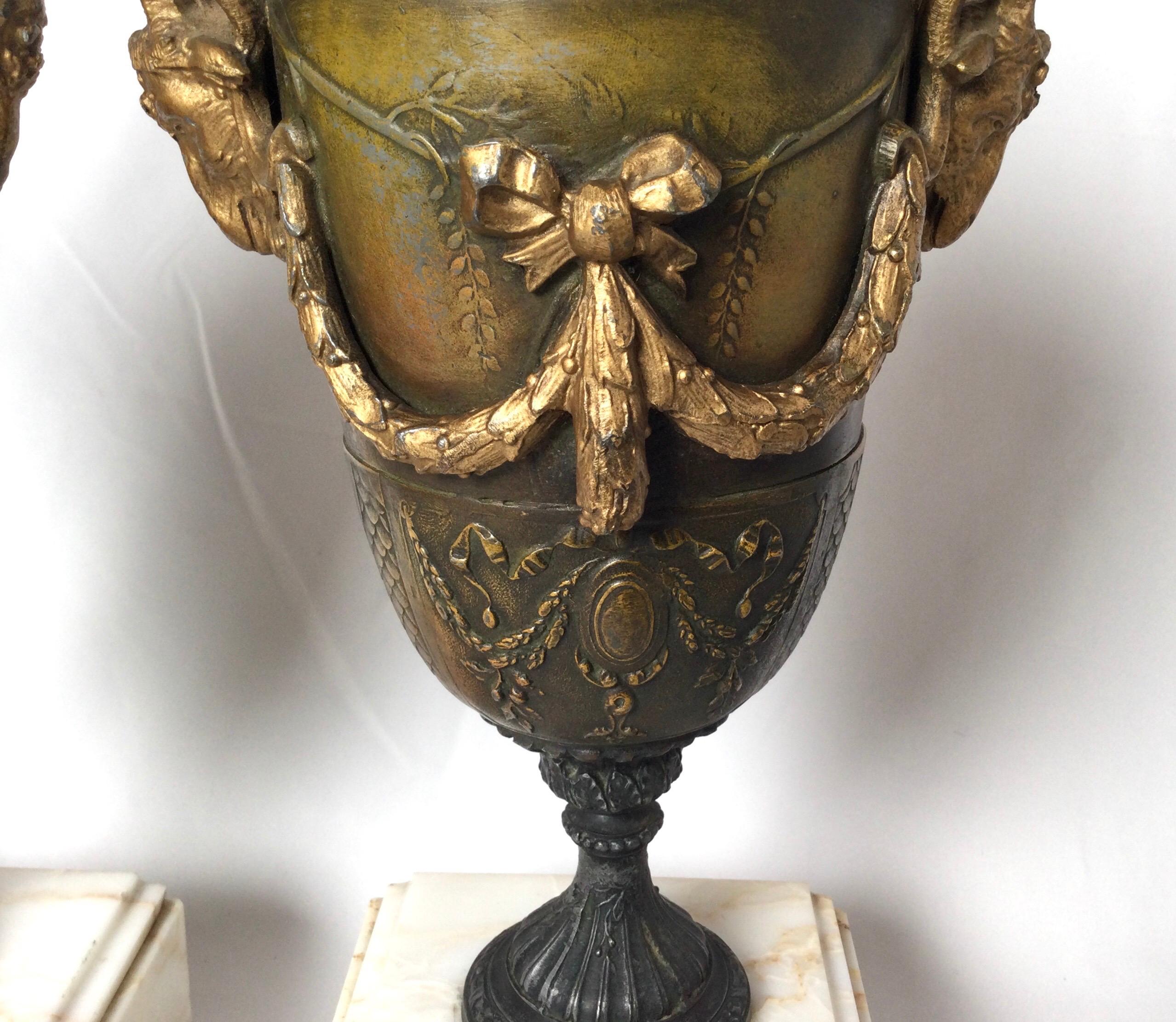 Victorian Pair of French Style Marble and Patinated Metal Garniture Urns with Rams Heads For Sale