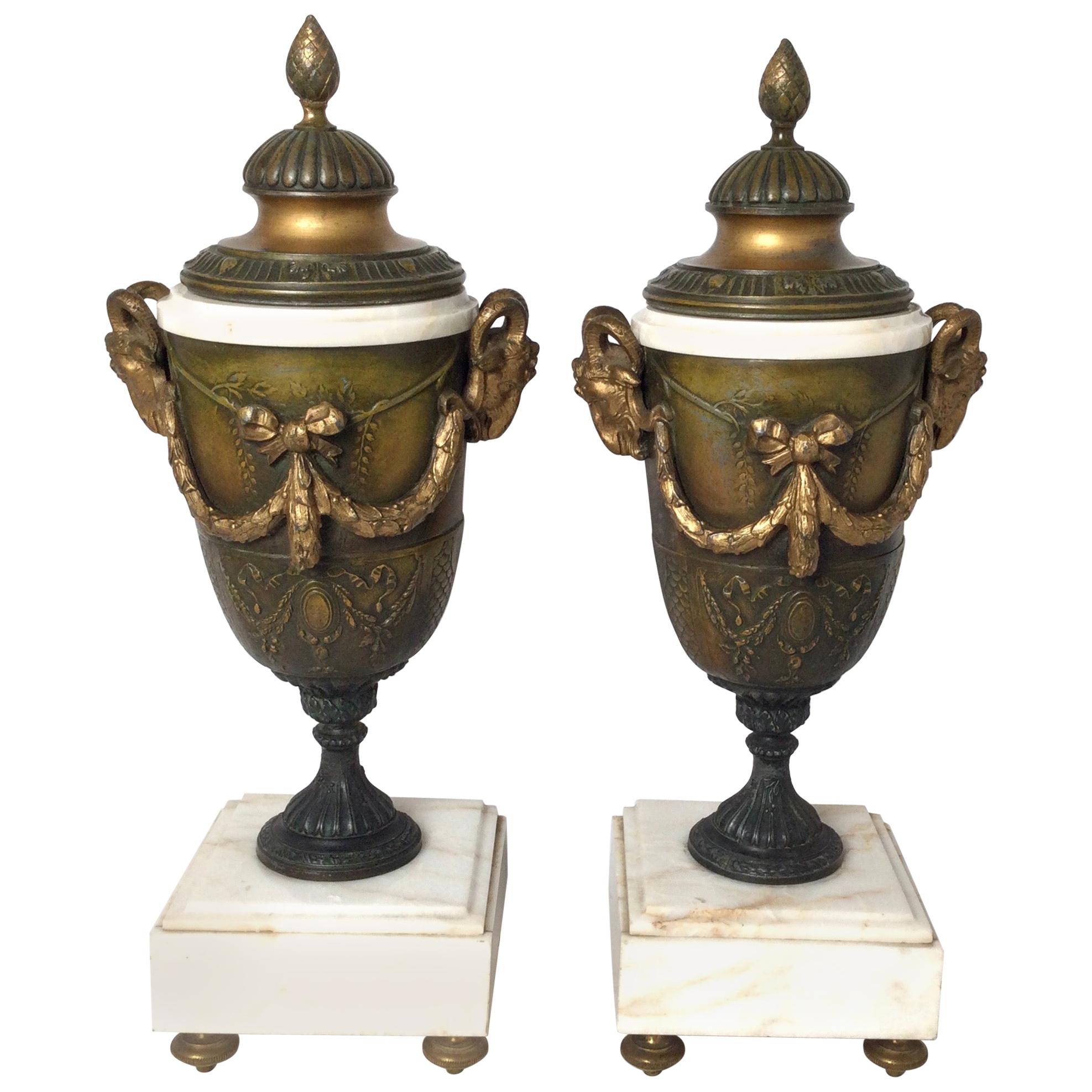 Pair of French Style Marble and Patinated Metal Garniture Urns with Rams Heads