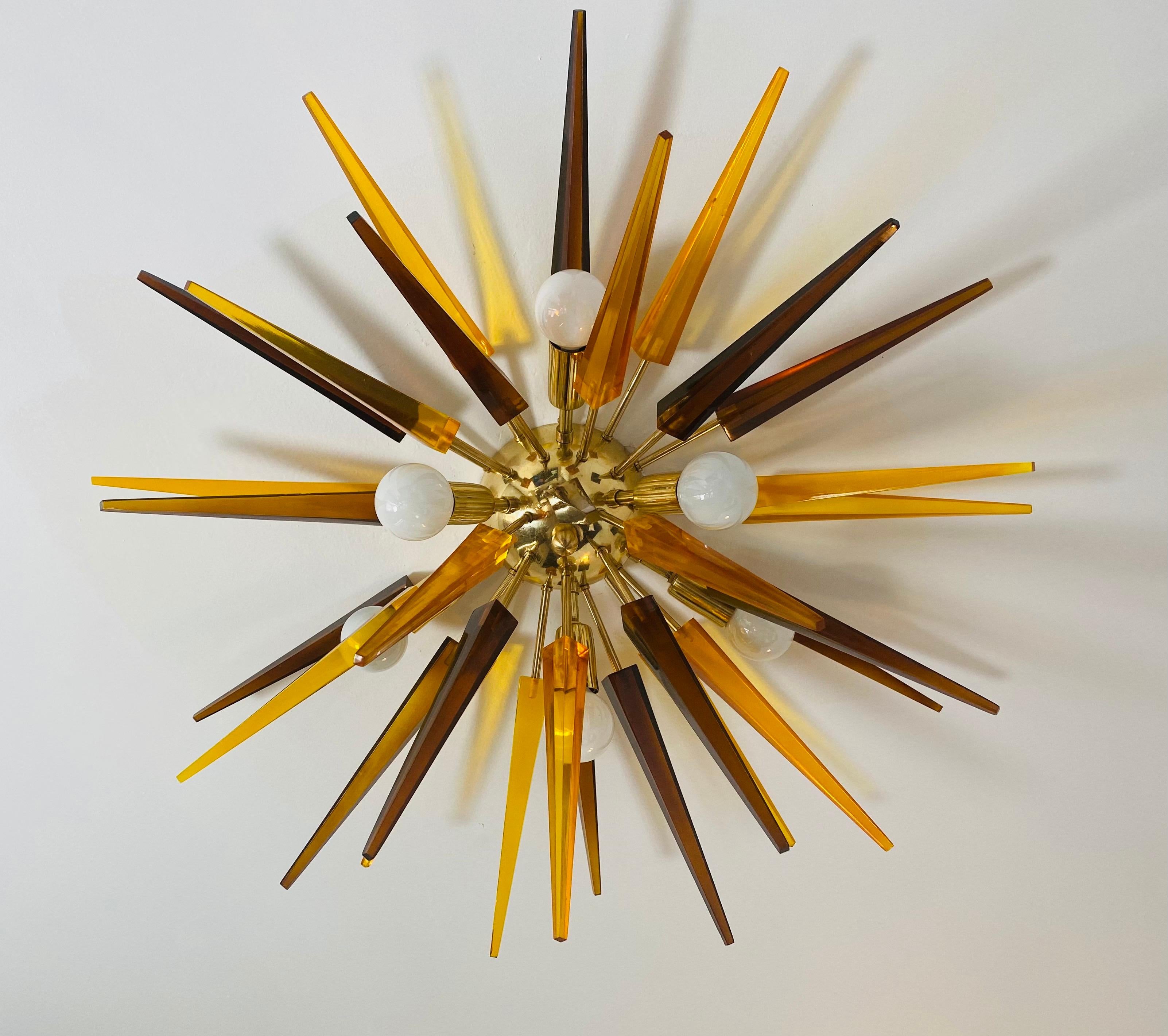 A wonderful orange and tea colored resin prisms on a golden brass fixture. Rewired. Six light sources. Can be used on the ceiling or wall.