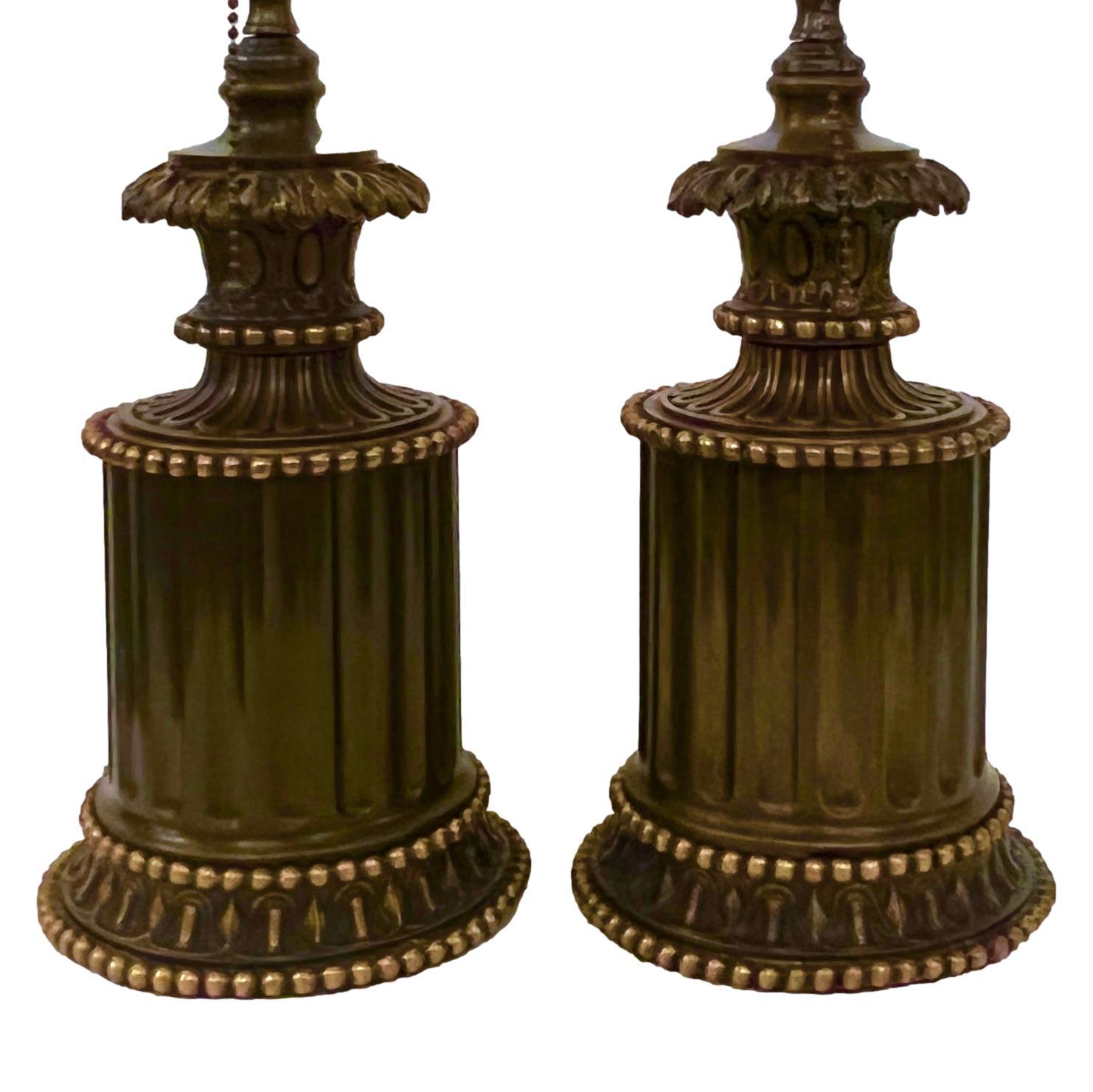 Pair of circa 1900 French oil lamps with patinated and gilt finish, electrified.

Measurements:
Height of Body: 11
