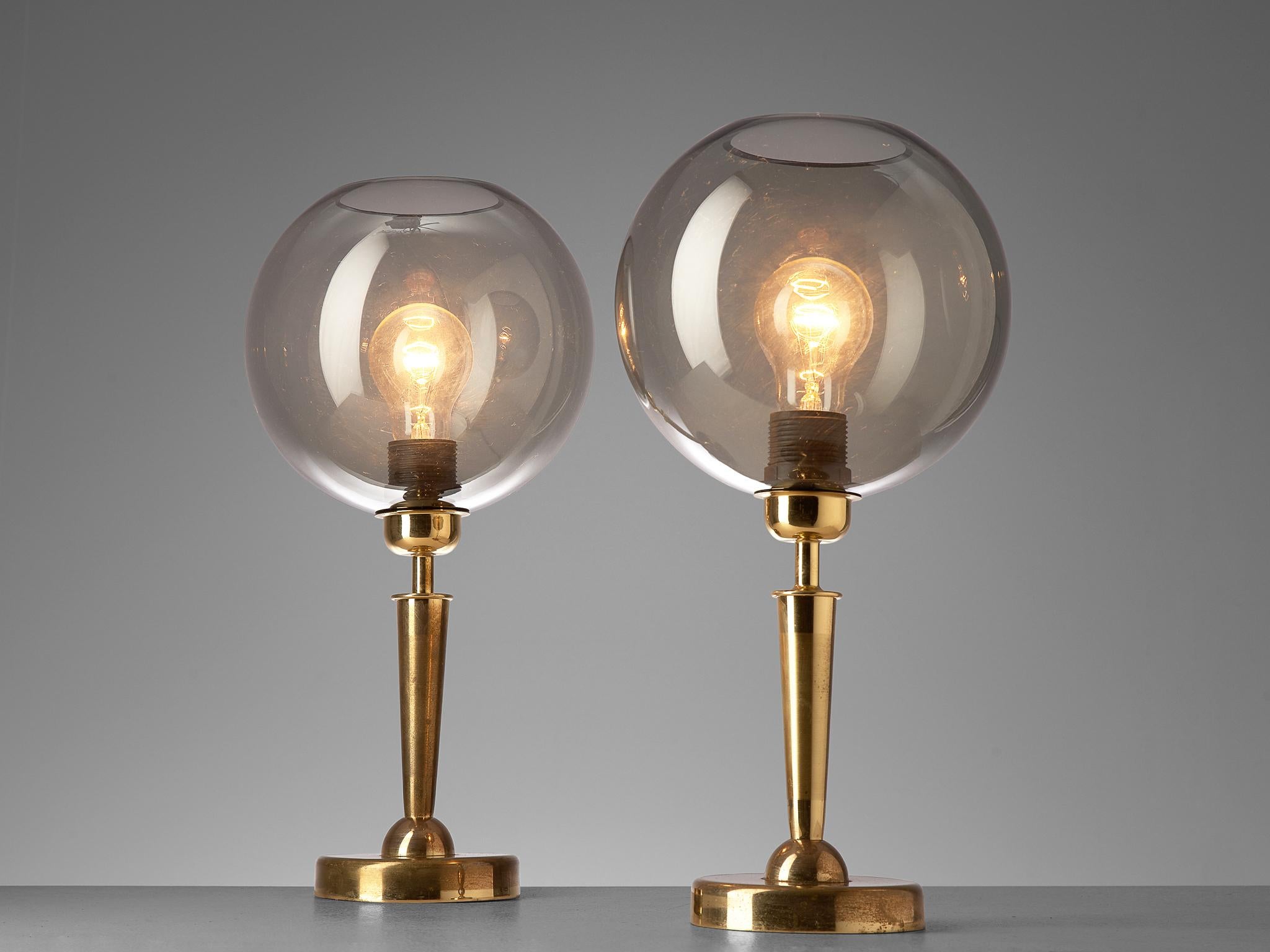 Table lamps, brass and glass, France, 1970s

Elegant table light composed of brass and mounted with a spherical shade in smoked glass. The table lights are manufactured in France during the 1970s. Please note we have a large amount available of
