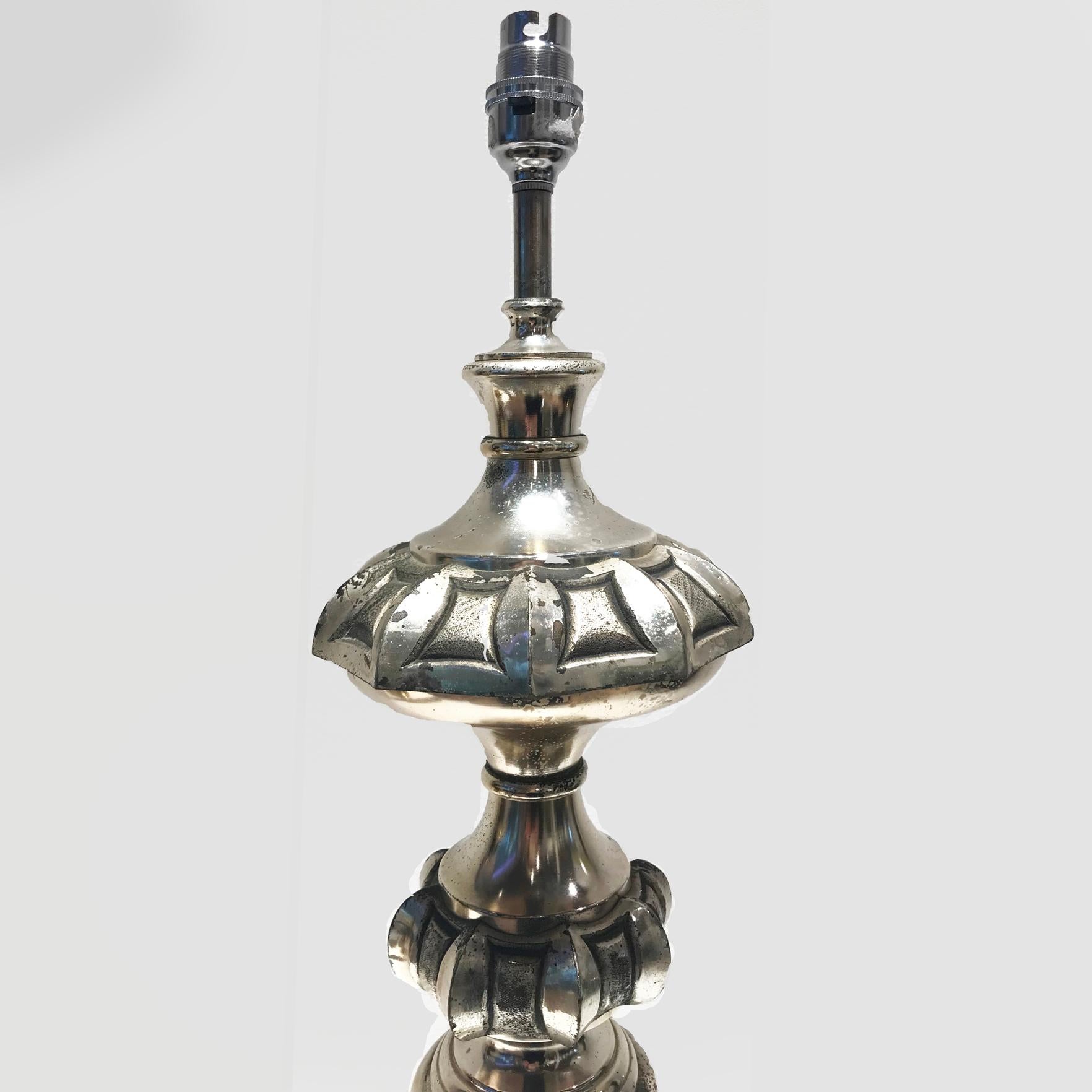 Pair of highly decorative silver plated French table lamps from mid-20th century. Both table lamps feature interesting surface qualities as the silver plate has naturally oxidised over time, creating a beautiful patina. Sold as a pair. Lampshade is