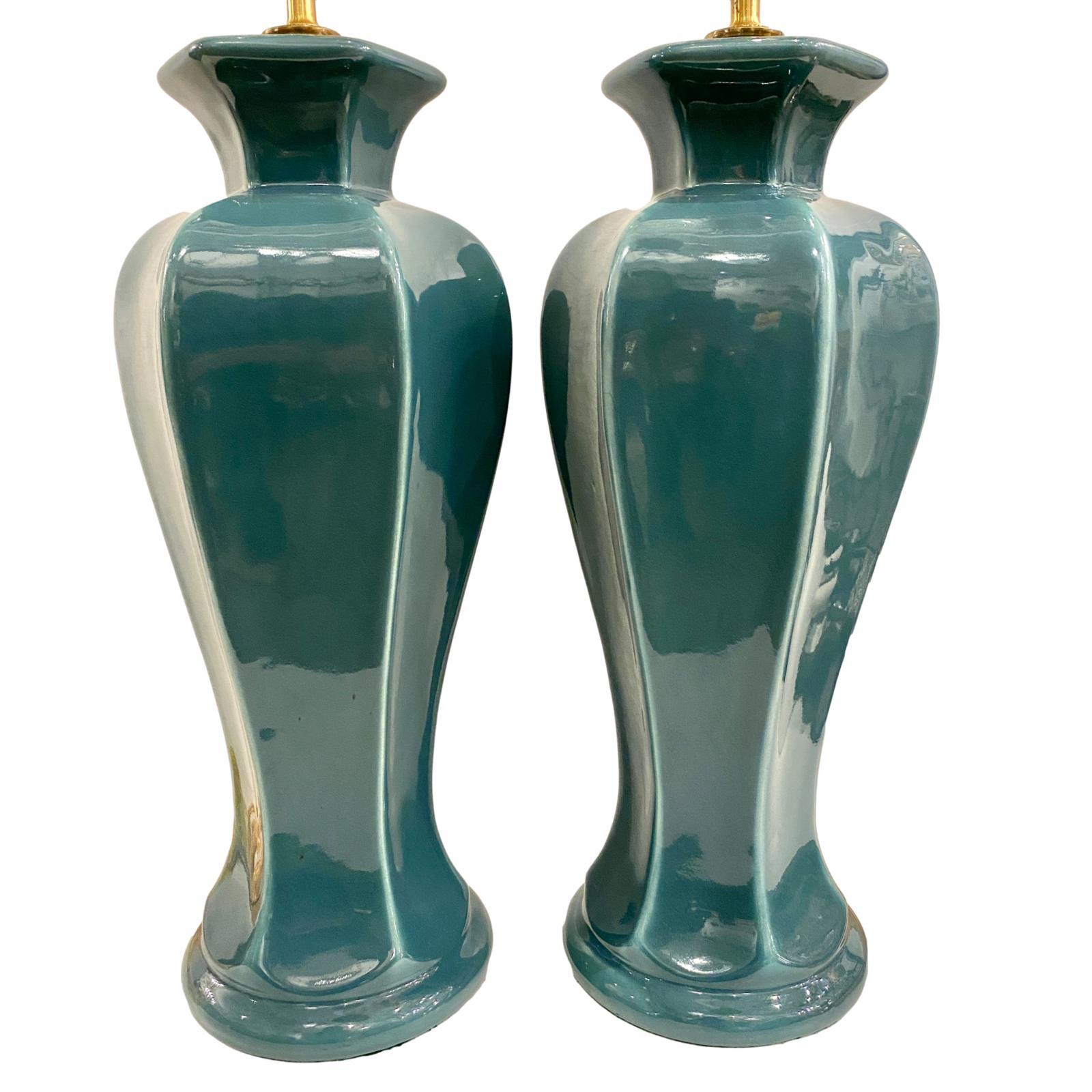 A pair of circa 1950s vase shaped teal glazed porcelain table lamps.

Measurements:
Height of body 18