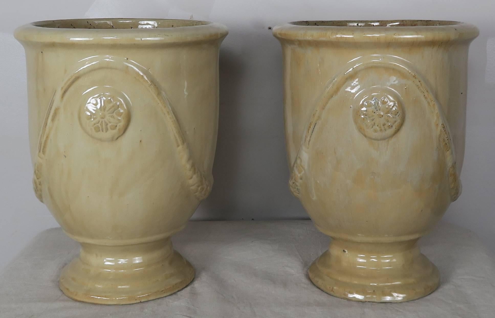Pair of French glazed terra cotta pots in a soft buttercream yellow coloration.
 