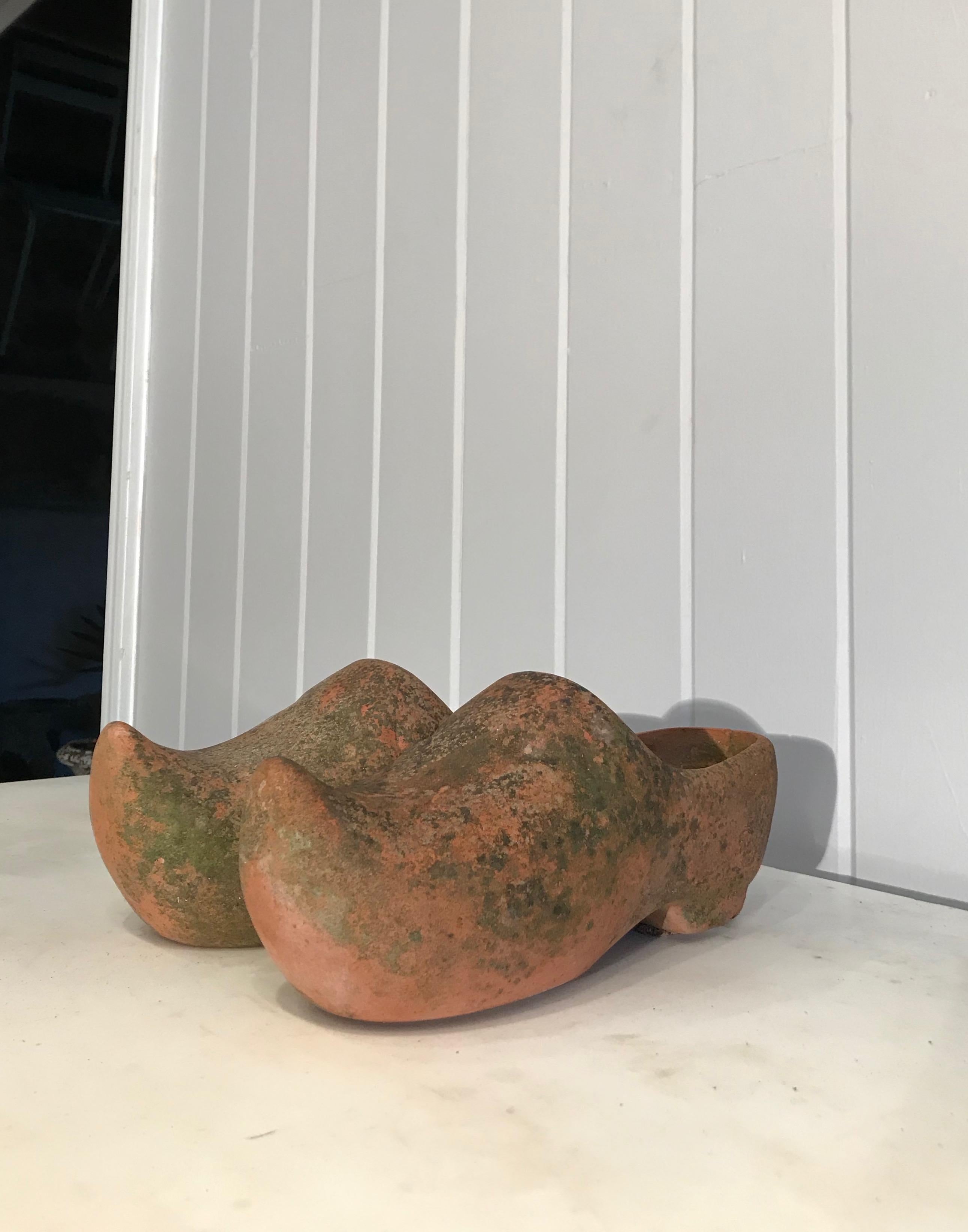 We love these terracotta planters for their novel form and lovely lichened and greening surface. Perfect placed on a windowsill and potted up with spring bulbs and creeping thyme, they will give any environment a perky lift. Both have drain holes in