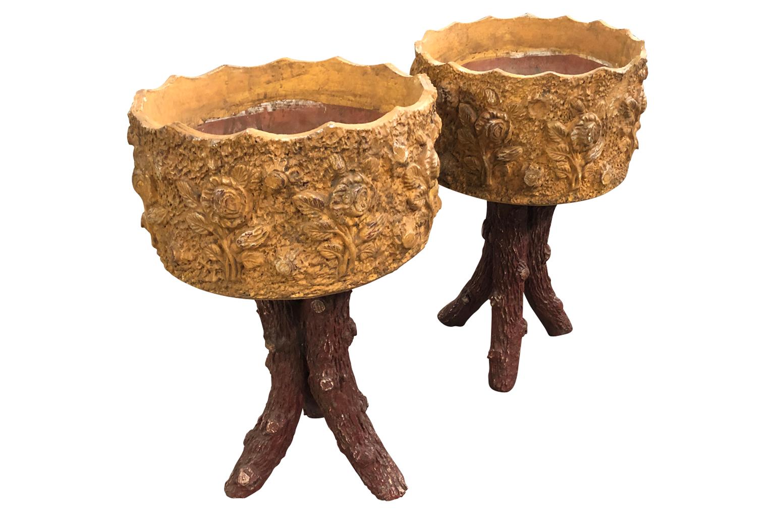A very charming pair of French glazed terracotta jardinières of Faux Bois styling. Wonderful decorative accent pieces.