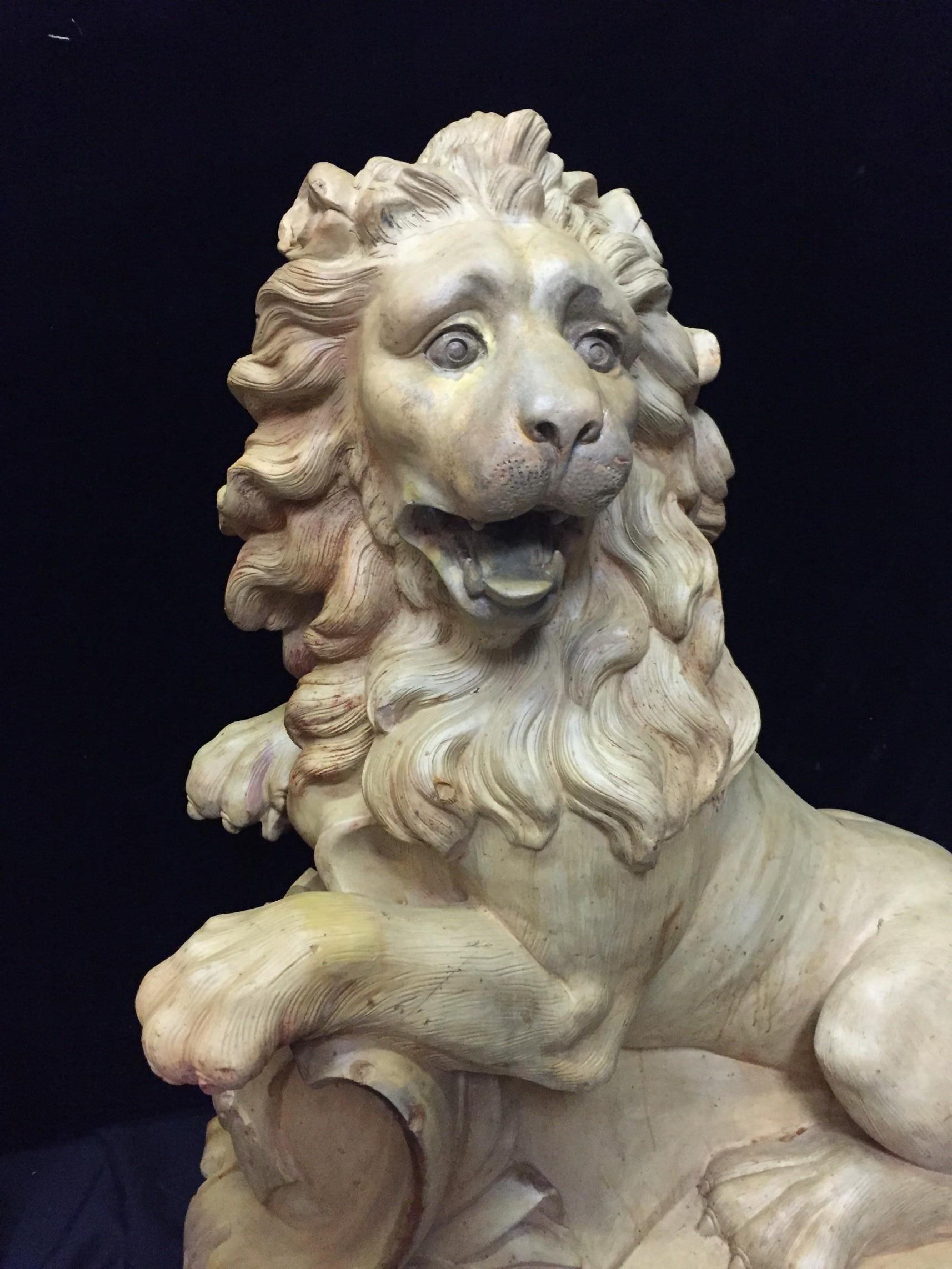 Spectacular opposing pair of late 19th-early 20th century French terracotta sculptures of life-size lions. Signed Mandeville: Bernier.
Both beautiful lions are roaring as they are inclined with their paws stretched on a floral crest. Both with