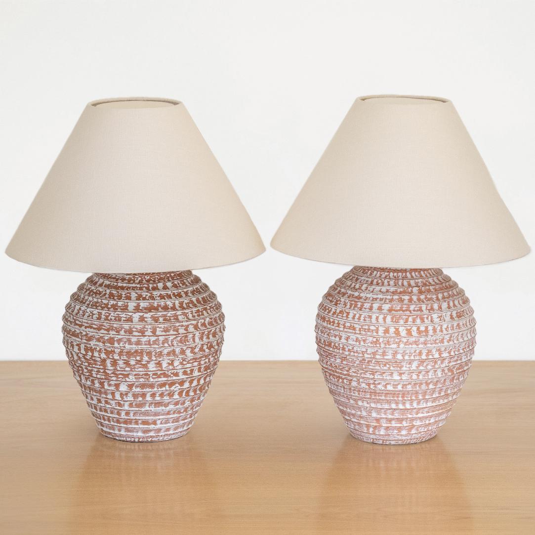 Unique pair of vintage large terracotta table lamps from France, 1950's. Large jug shape base made of red terracotta with decorative horizontal grooves and painted white accents. Each lamp is unique with slight variations. Newly rewired and new