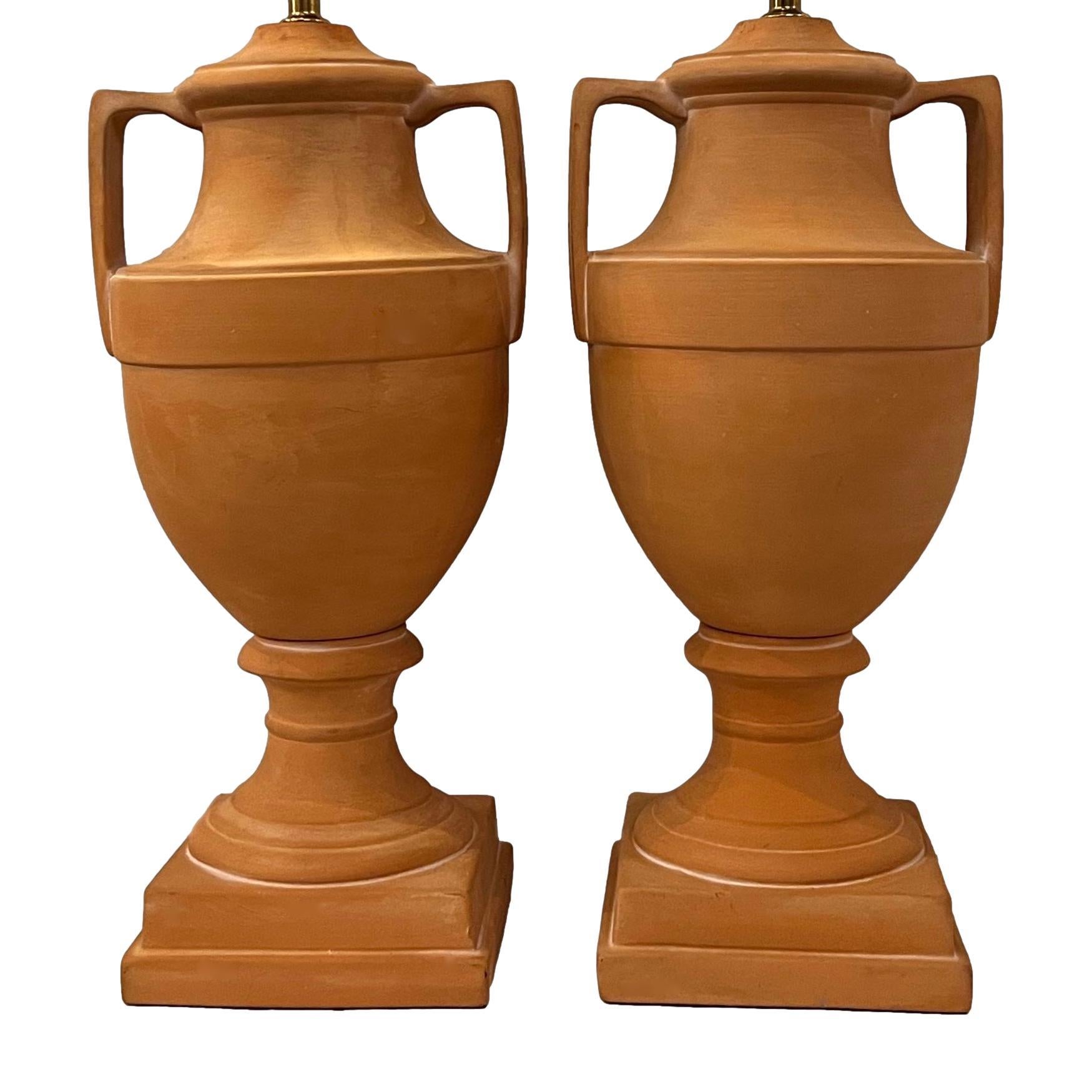 A pair of circa 1950's French unglazed terracotta urn-shaped table lamps.

Measurements:
Height of body: 19