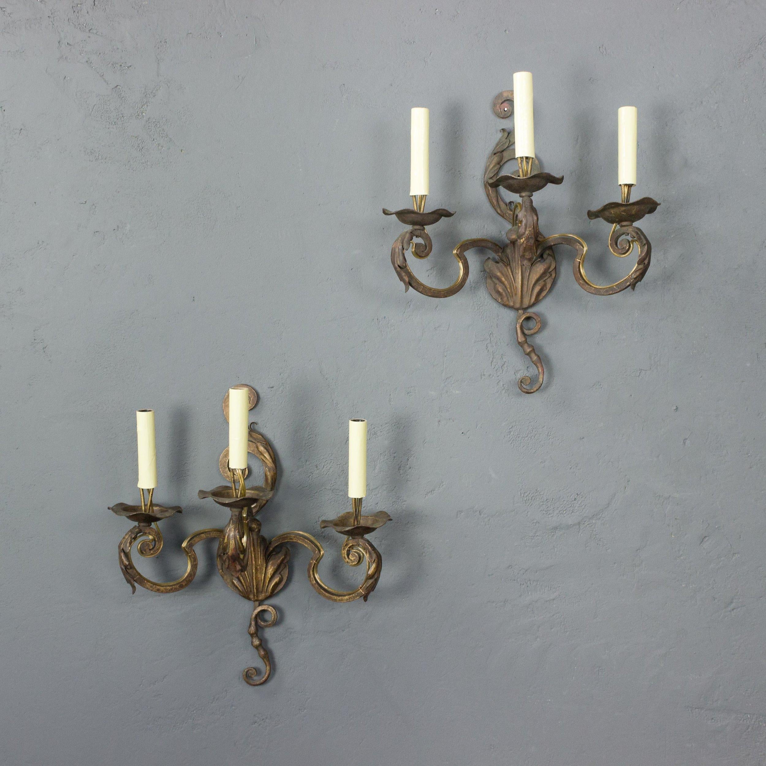 Pair of gilt metal, three armed sconces, wrought iron with applied leaf decorations. French, 1920s. Rewired (not UL listed). Very good vintage condition.

Ref #: LS0317-01

Dimensions: 16