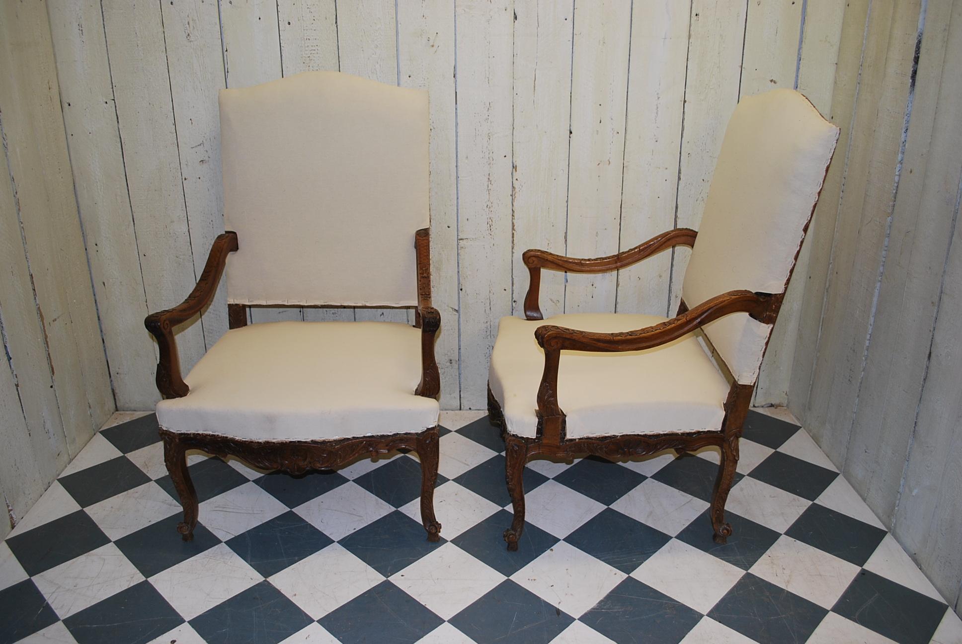 A good quality pair of French throne chairs or fauteuils, circa 1890. Beautifully carved in solid walnut with open arms and upholstered seats and backs. God generous proportions with nice wide seats and very sturdy, ready for upholstering. Standing
