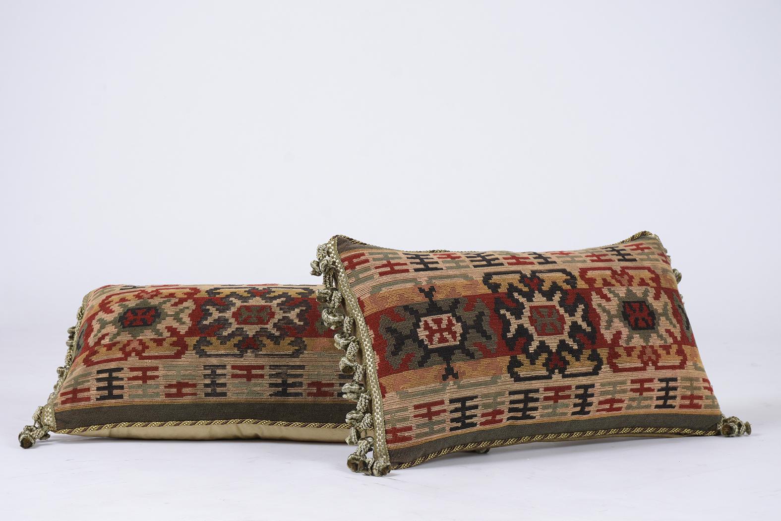 This beautiful pair of French 19th century accent decorative pillows are made out of antique floral pattern tapestry and have a gold color velvet fabric on the sides and back. They are also beautifully finished with decorative multicolored tassels,
