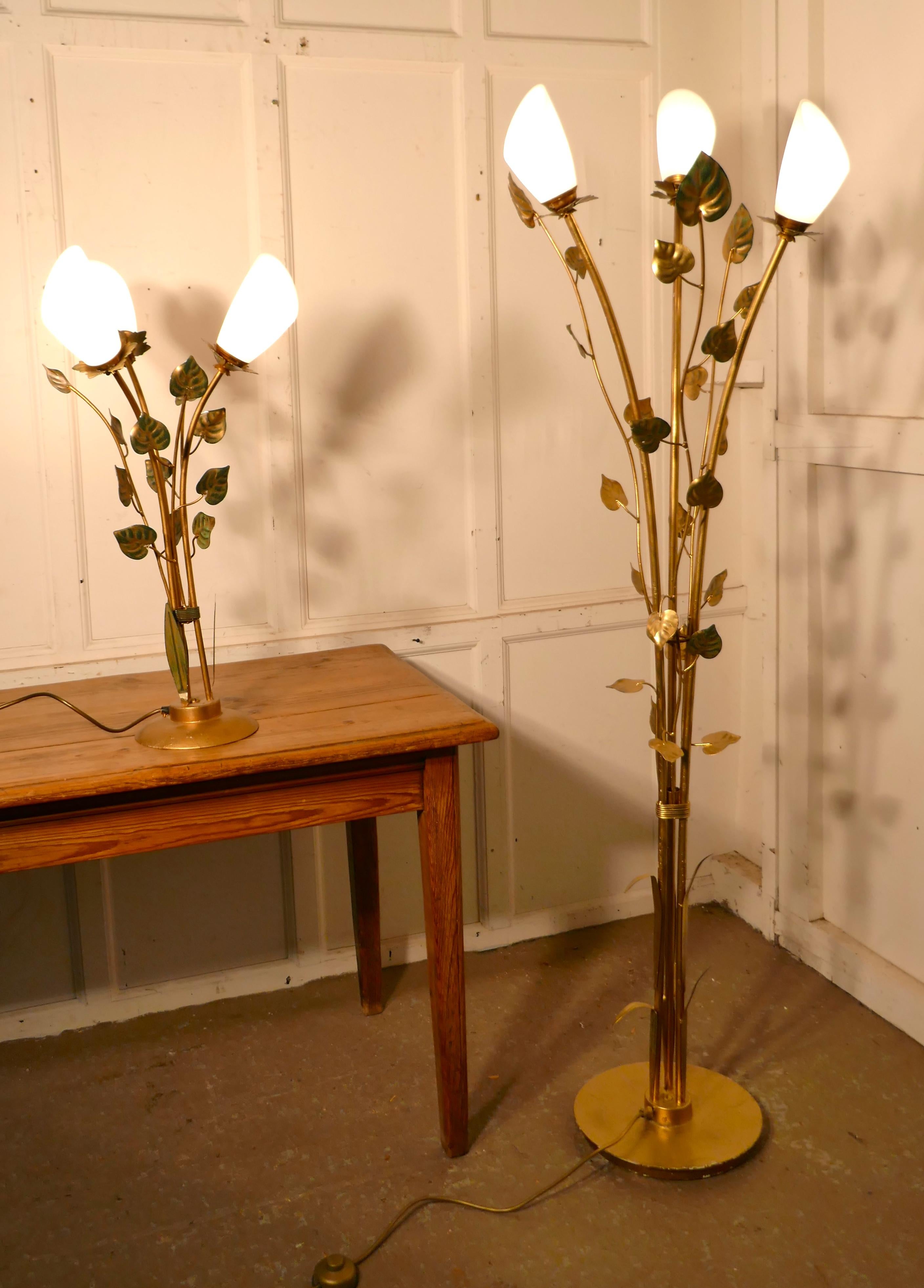 Pair of French toleware lamps with leaves in the orangery style, floor and table lamp.

The lamps have a brassed finish with hints of green, they are designed to look like delicate leafy plants
Each lamp has a round base, with several upward