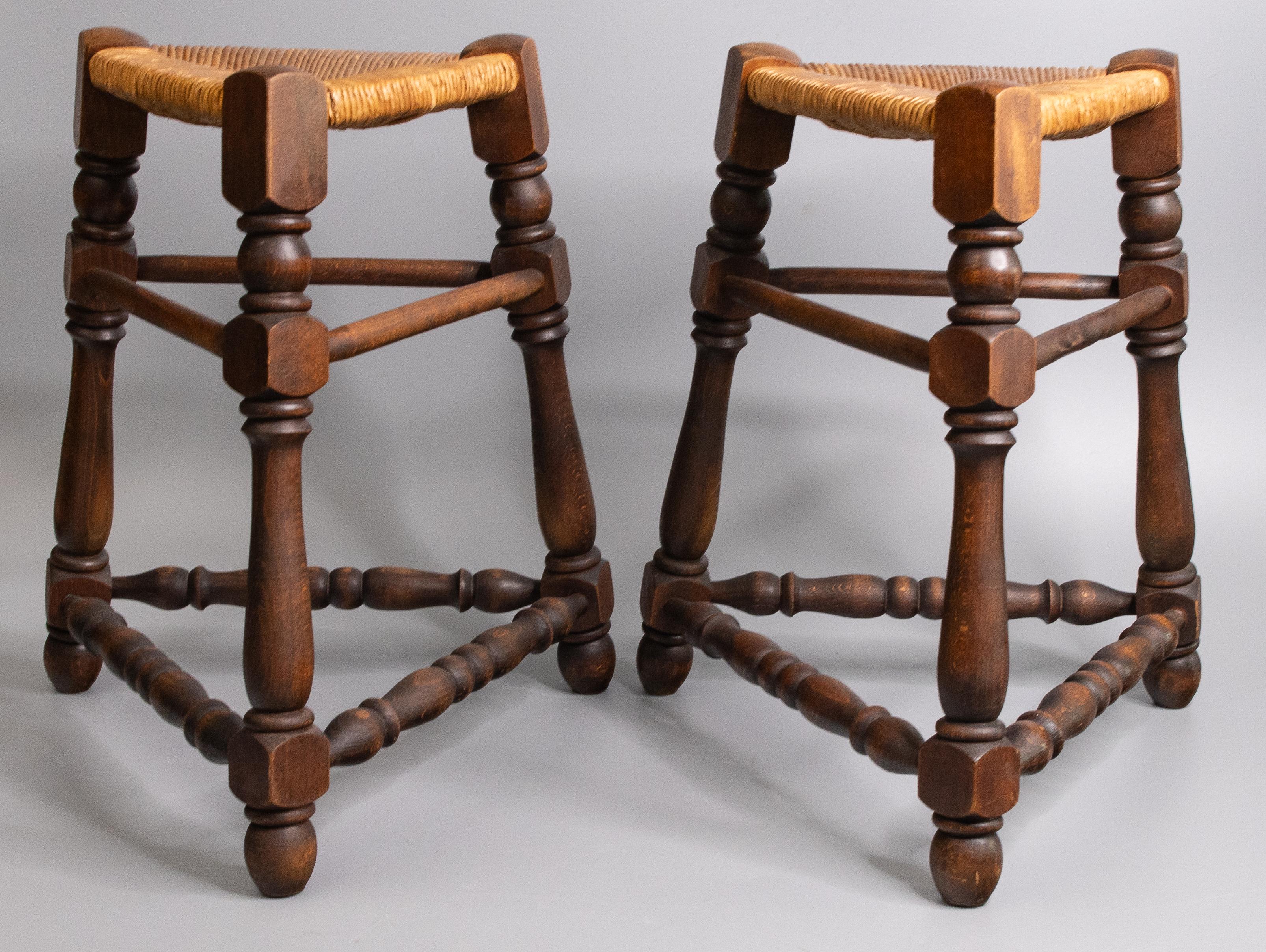 A fine pair of antique French oak tripod stools with woven rush seats, circa 1900. These charming stools are a stylish triangular shape, solid and sturdy, with hand turned legs and stretchers in a lovely patina. A rare find!

DIMENSIONS
16ʺW × 16ʺD