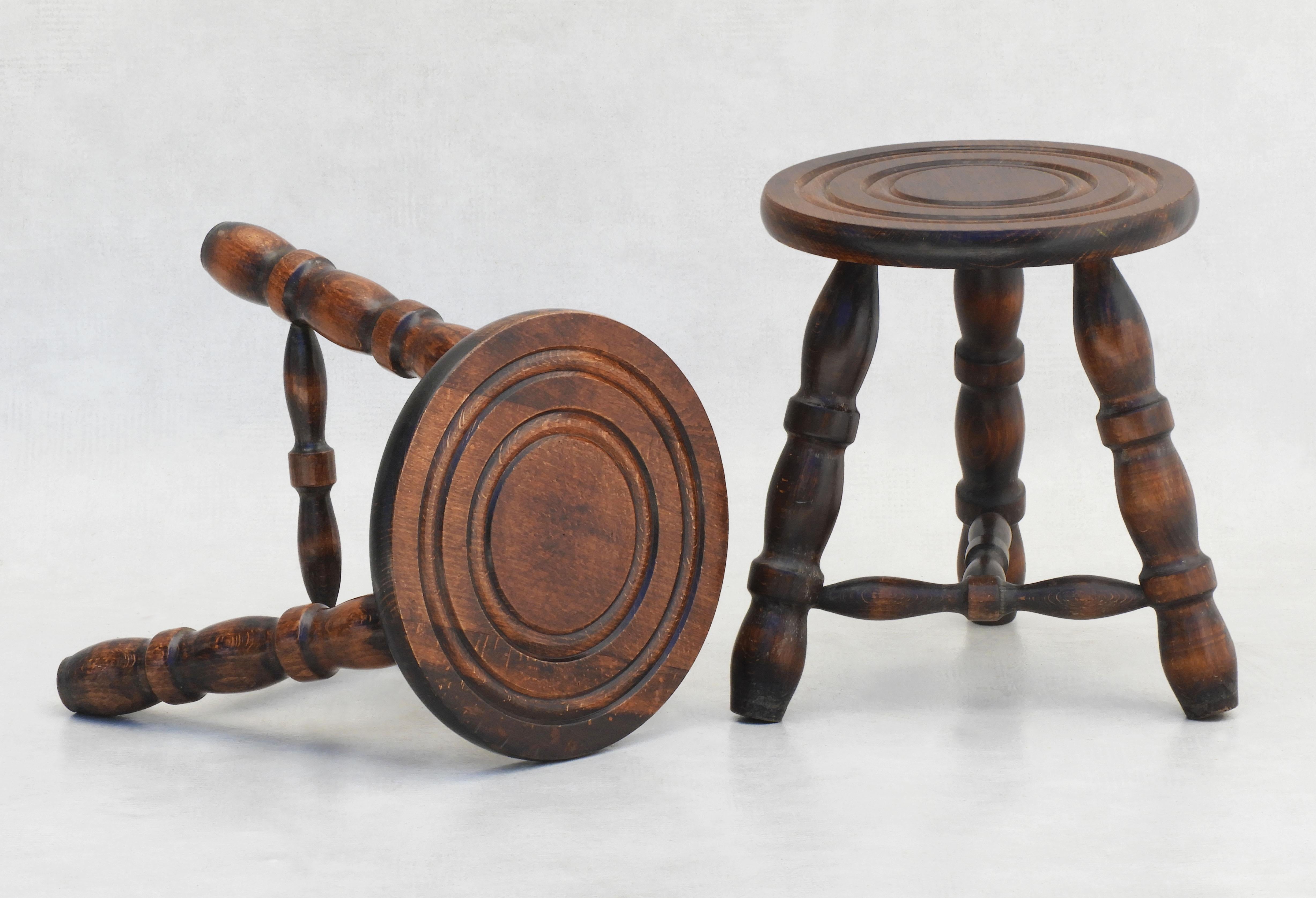 Pair of French tripod stools c1950

A good pair of wooden Basque-style wood tripod stools from midcentury France. Versatile handcrafted three-legged tabouret stools, which can also be placed as nightstands or side tables in almost any room.
