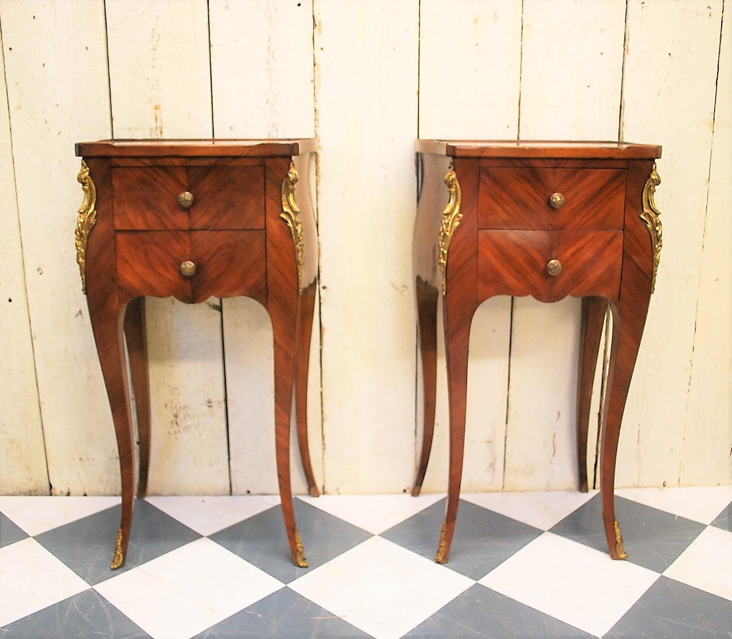 A beautiful pair of French tulipwood bedside cabinets or nightstands, circa 1900. Standing on cabriole legs with two oak lined drawers, original brass mounts and knobs. Veneered in patinated quarter veneered tulipwood. A little earlier than most of