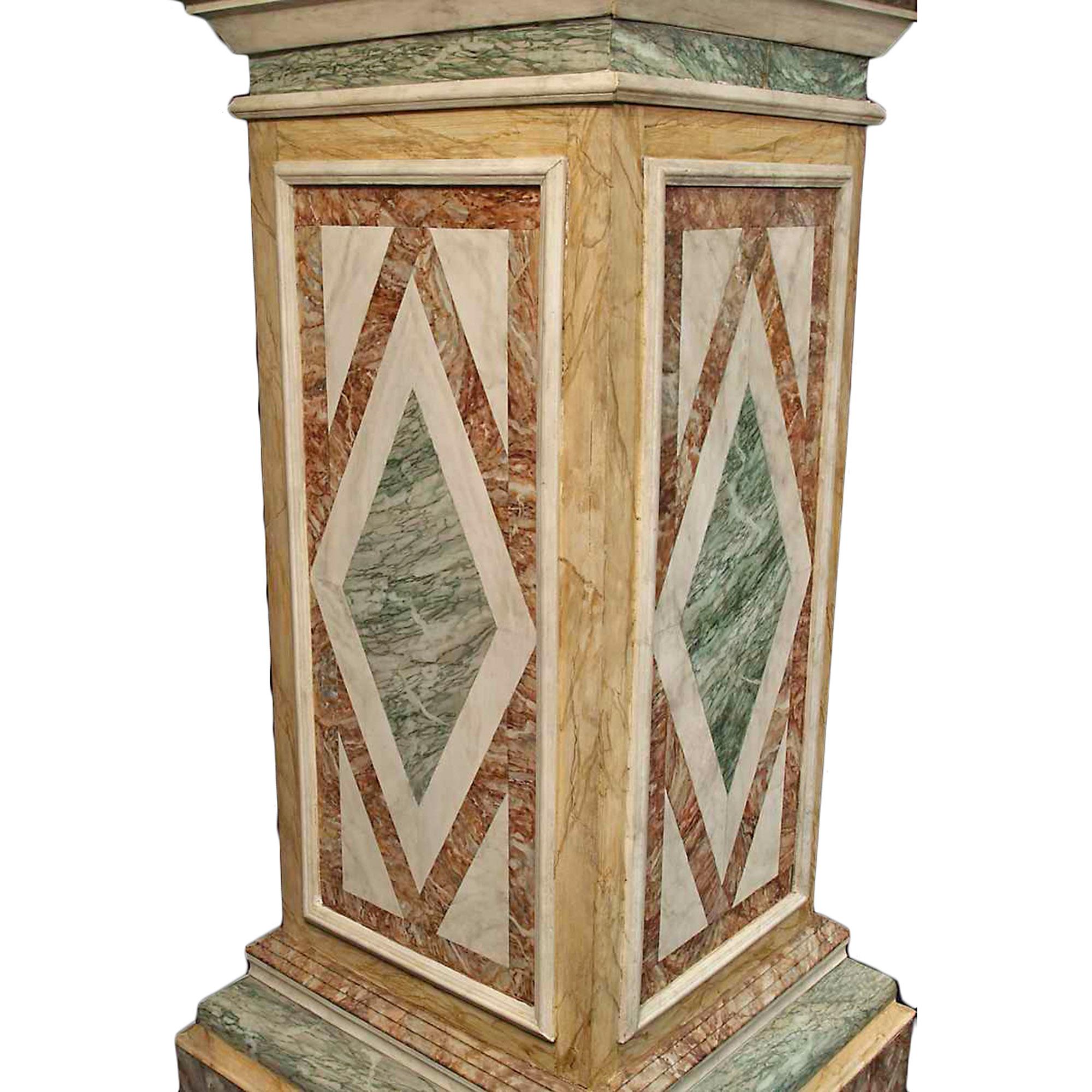 An attractive and high quality pair of French turn of the century faux marble painted wood pedestals. The square base has thick mouldings while the central paneled support has a very detailed diamond shaped design all sides, with a door in the back.