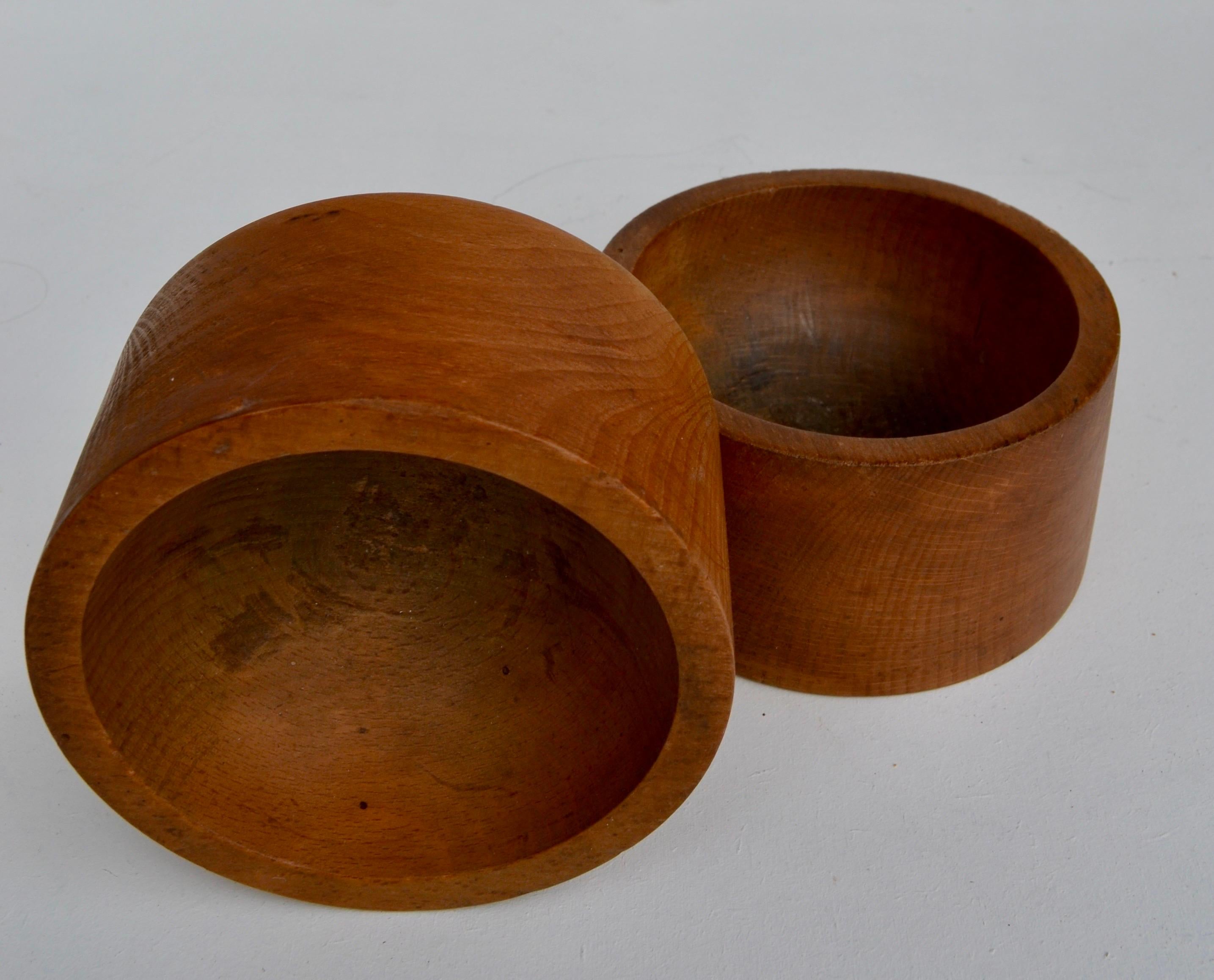A pair of French turned beechwood catchalls. Nice patina and smooth, minimalist shape. France, 1950s.