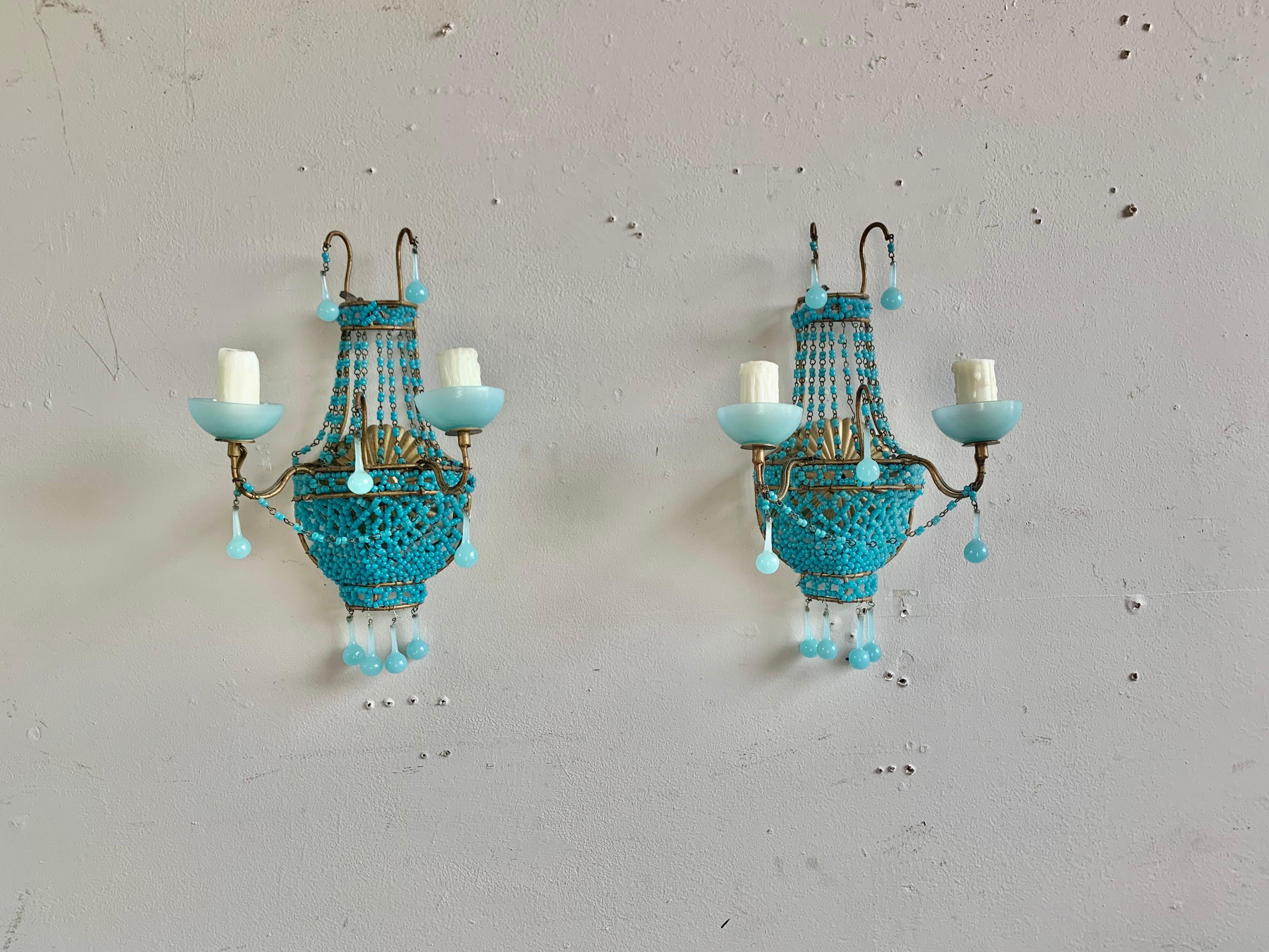 Pair of French turquoise colored basket beaded sconces with aqua drops. The frame is metal and finished in gold leaf. 
 Original aqua colored bobeches. The sconces are newly rewired with drip wax candle covers. The are ready to install.