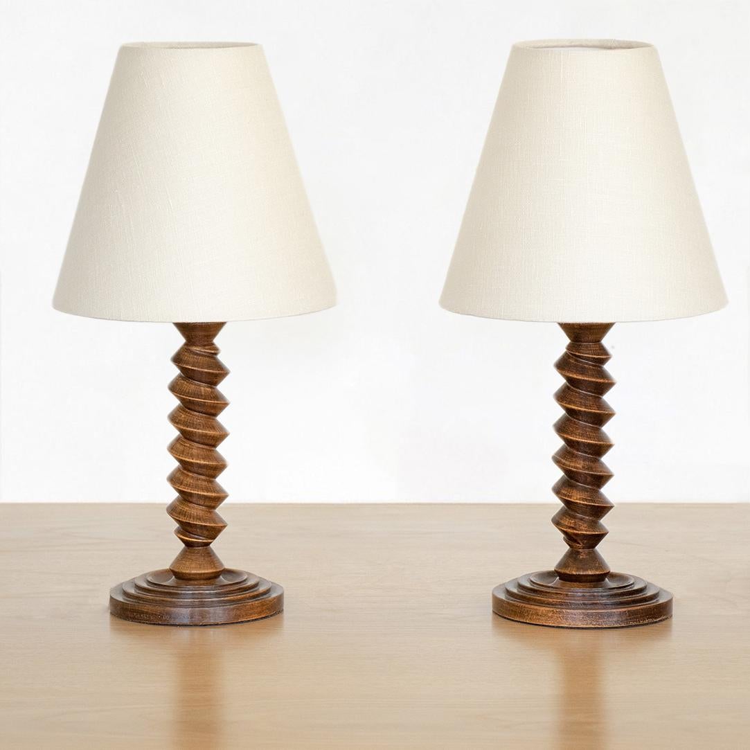 Beautiful pair of French twisted wood table lamps from France, 1940's. Original wood coloring and newly re-wired with new linen shades. Sold as a pair.