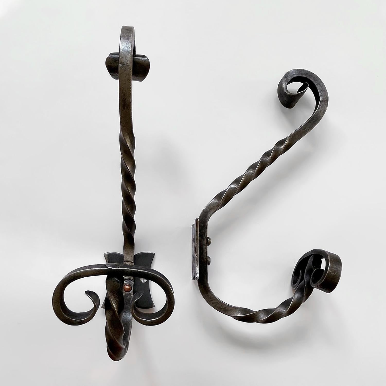 Pair of French twisted wrought iron double hooks
France, mid century
Beautifully sculpted twisted wrought iron J hooks with upper and lower storage
Finished with curved iron detailing
Each wall mounted hook is supported by a single bracket which