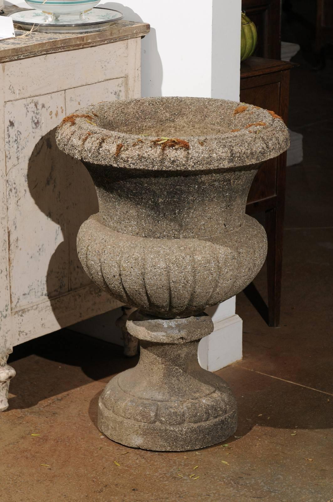 A pair of French stone planters in the style of the vase Médicis, from the late 19th century. Each of this pair of stone planters features a chalice shape, typical of the original Medici vase kept at the Uffizi gallery in Florence. Inspired by the