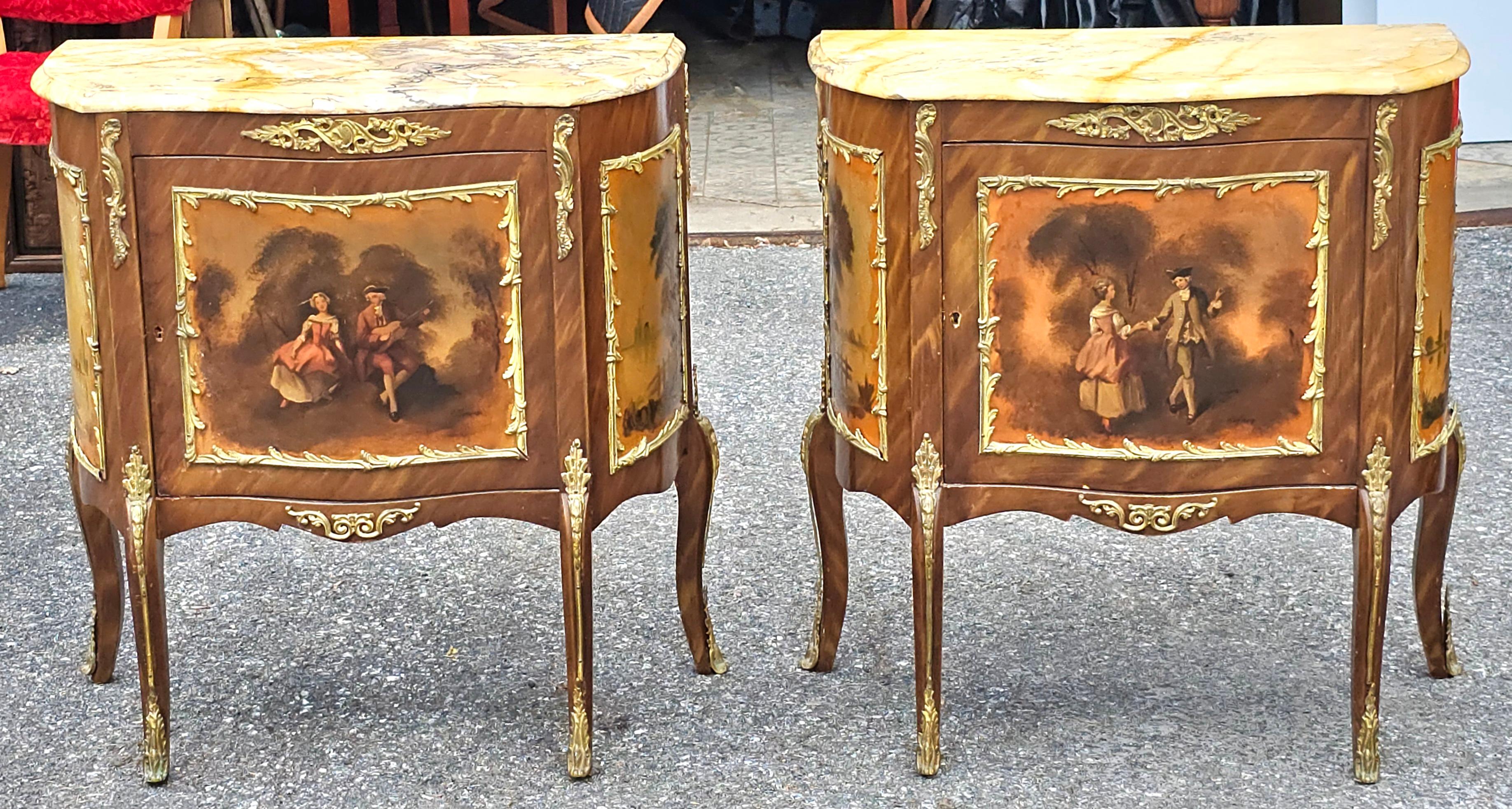 A pair of French Vernis Martin style painted commodes, each having marble tops over single doors with pained scenes framed by bronze mounts. Painting signed A Mancini and Kaufman. Supported on cabriole legs.
Each Commode/ console comes functional