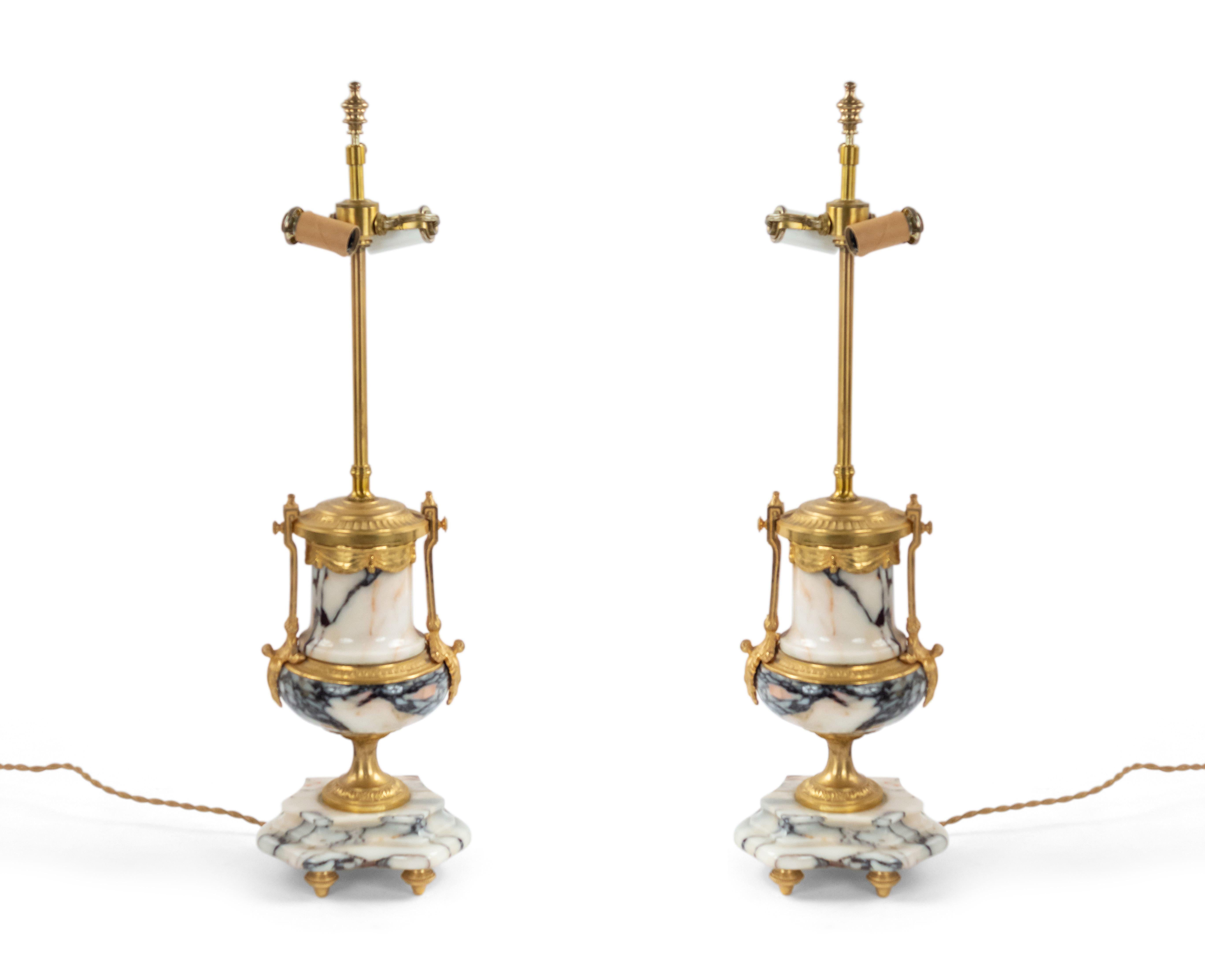 Pair of French Victorian (19/20th Century) white and black veined marble urn form lamps with gilt bronze side handles and trim (PRICED AS Pair).
