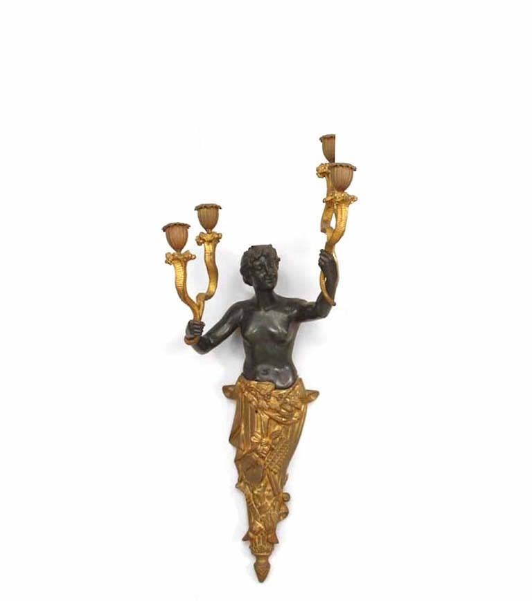 Pair of French Victorian bronze and gilt wall sconces with human figures holding a Pair of arms in each hand. (PRICED AS Pair)
