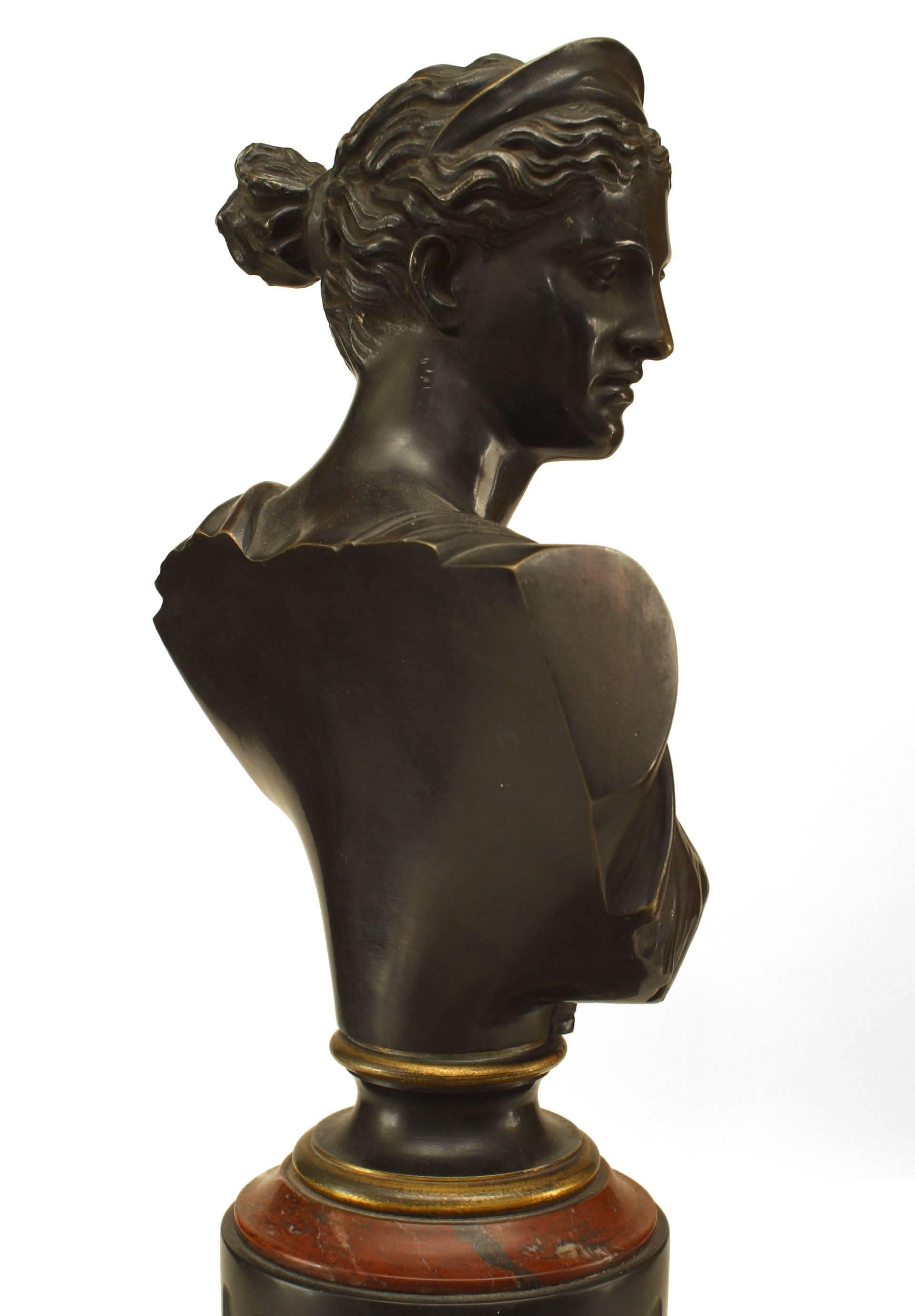 Pair of French Victorian bronze busts of Apollo and Diana mounted on a black marble square shaped base under a fluted column with red marble trim
