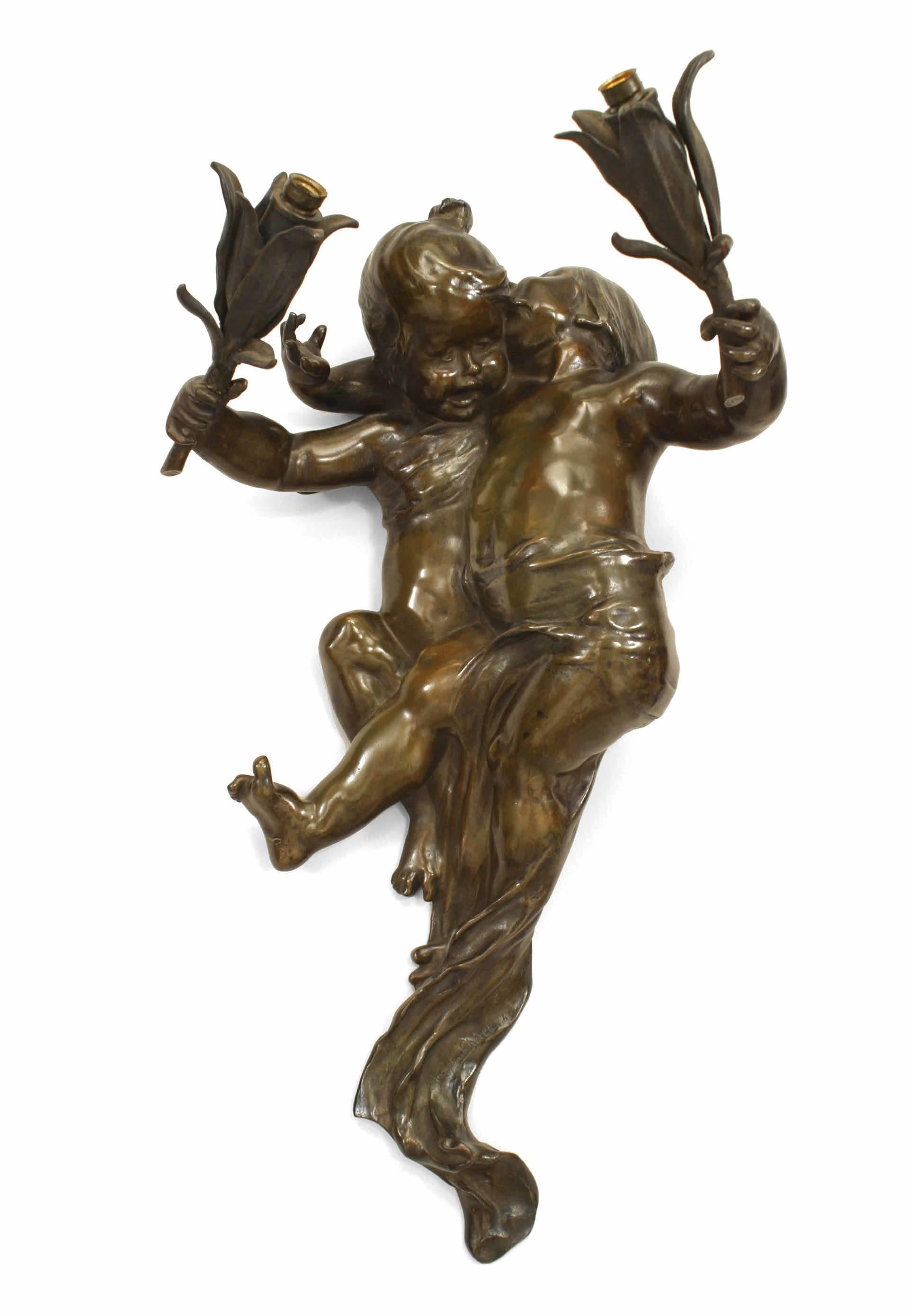 Pair of French Victorian bronze (with green patina) cherub-shaped wall sconces with two flower-shaped arms. (signed JOSEPH CHERET)(PRICED AS Pair)
