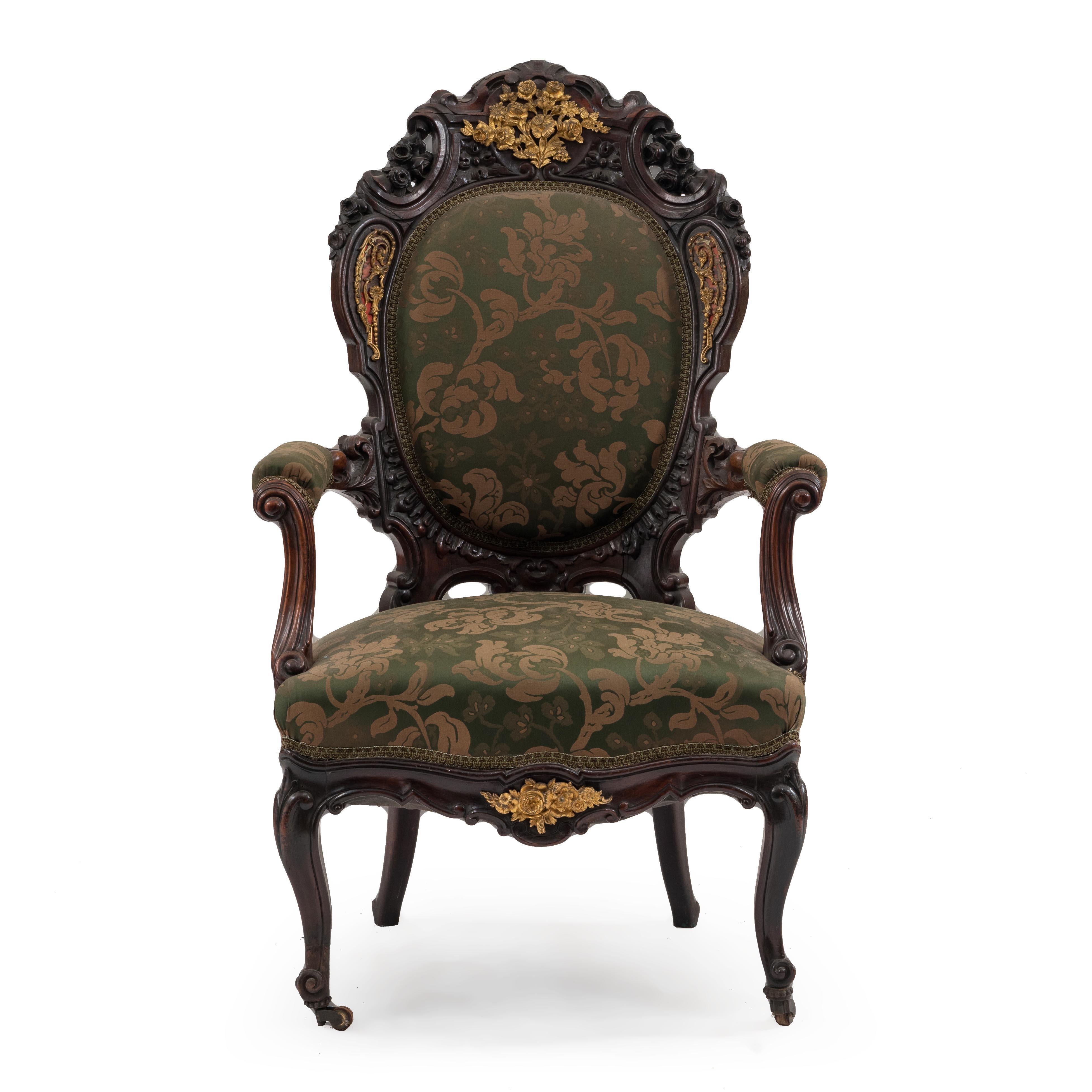 Pair of French Victorian carved rosewood armchairs with Boulle brass and tortoiseshell inlay and bronze trim.
  