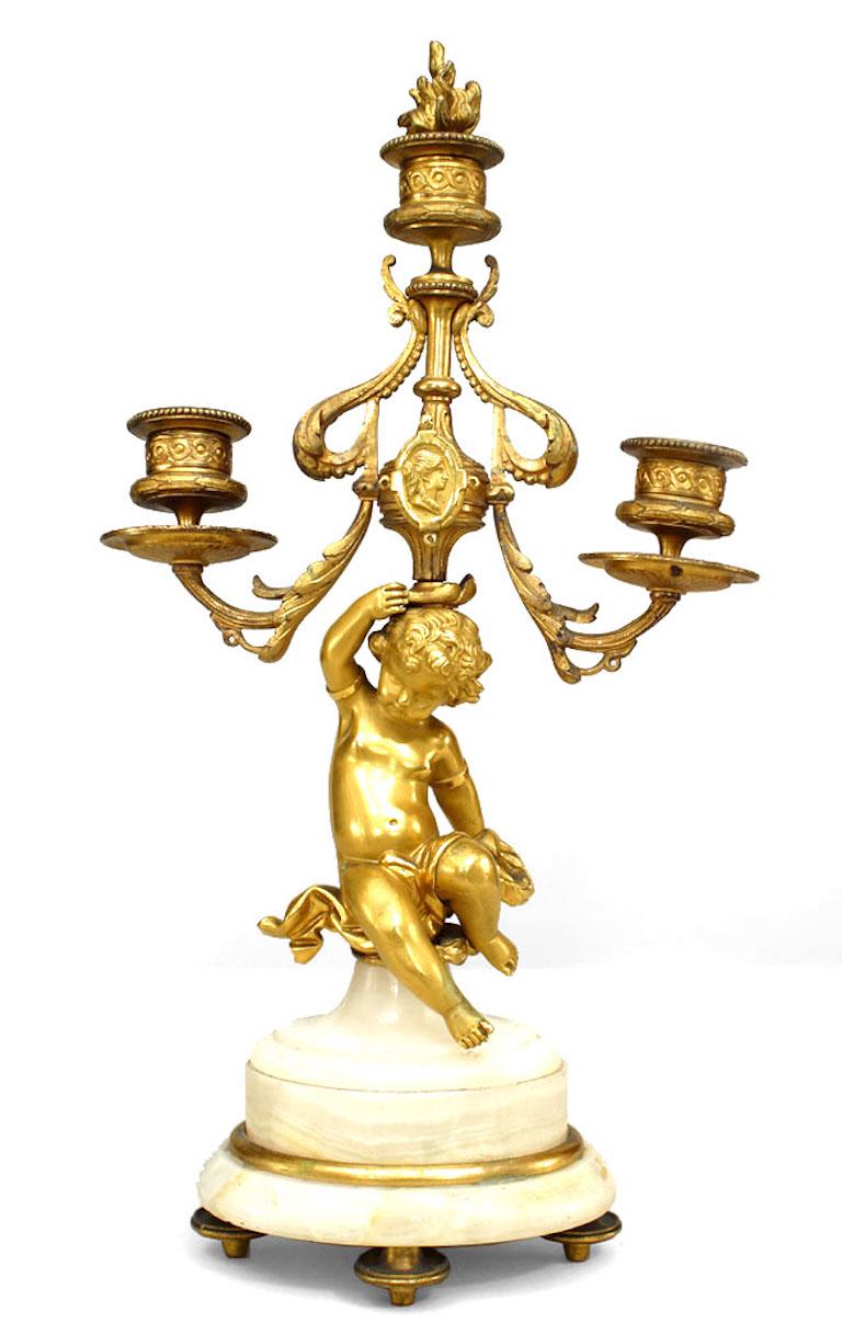 Pair of French Victorian bronze dore 3 arm candelabras with decorative cupid on an oval shaped onyx base with finial (PRICED AS Pair)
