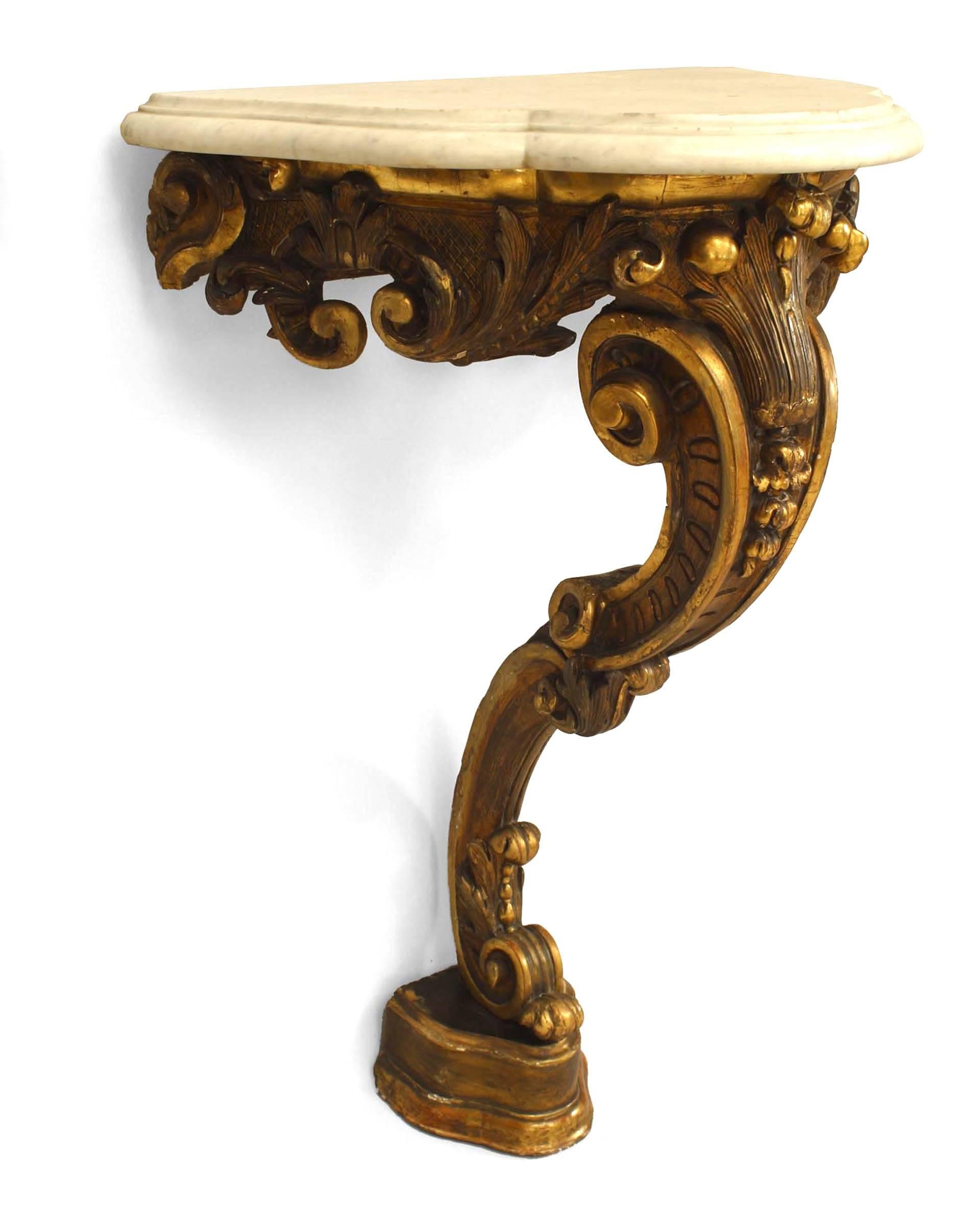 Pair of French Victorian gilt carved bracket consoles with scroll design and shaped white marble top (with a separate base section).
 