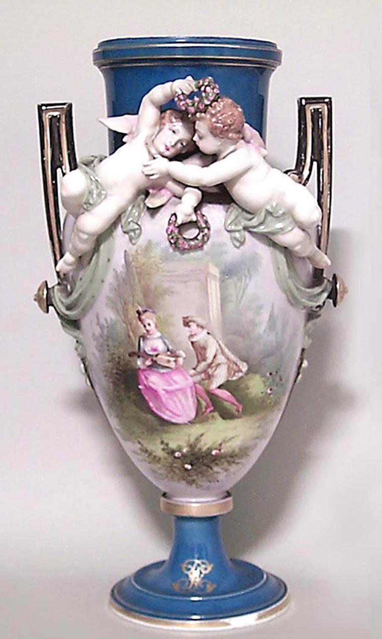 Pair of French Victorian Louis Philippe porcelain vases with two cupids in relief and painted couple in garden. (PRICED AS Pair)
