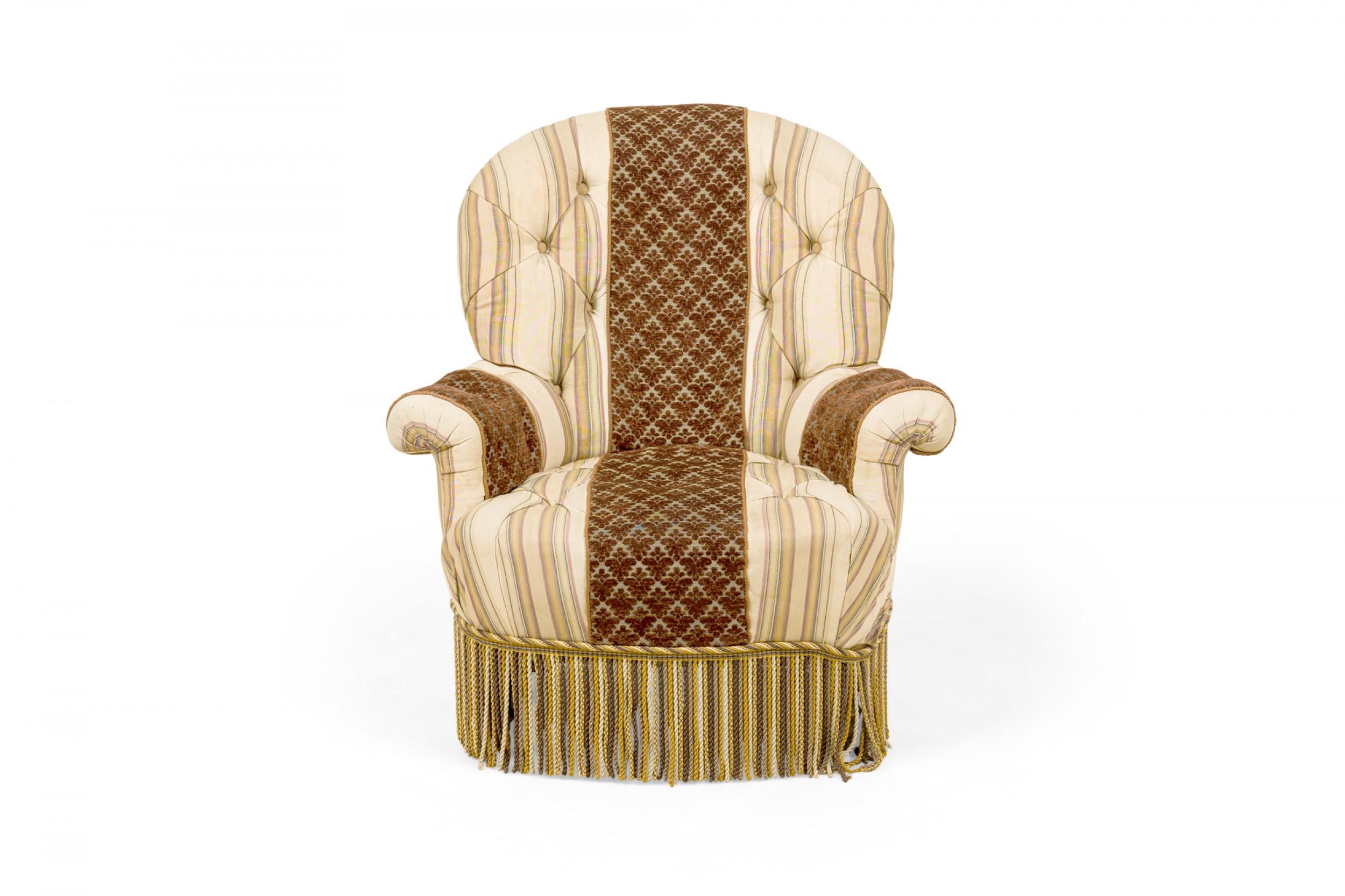 Pair of French Victorian-style armchairs with rounded backs and scroll arms, upholstered in a neutral toned striped fabric with a brown patterned velvet stripe running vertically down the center back, and armrests, accented with button tufting and