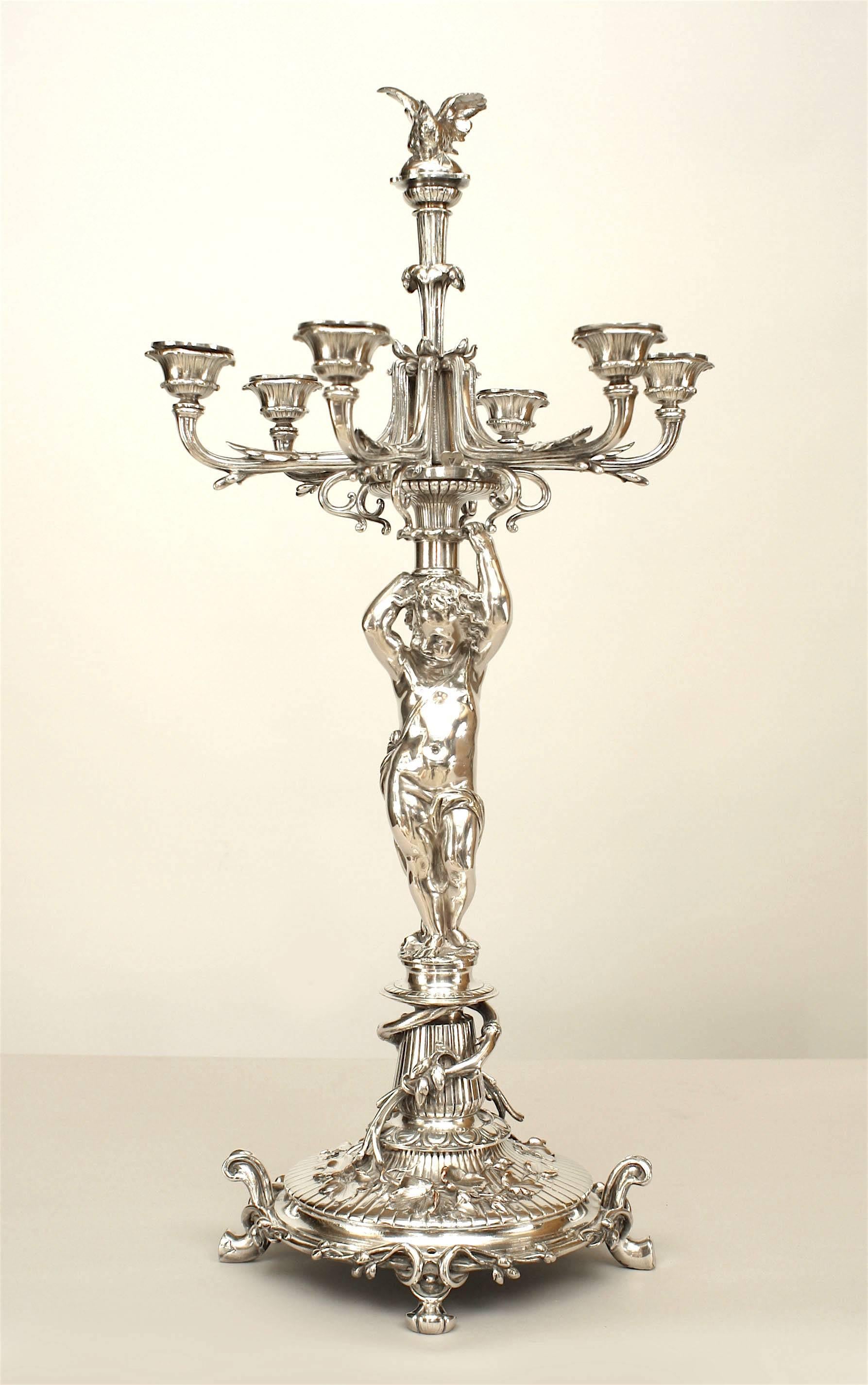 Pair of French Victorian silver plated candelabra with a cupid standing on a circular base and holding 6 branches (by CHRISTOFLE & CIE) (PRICED AS Pair)
