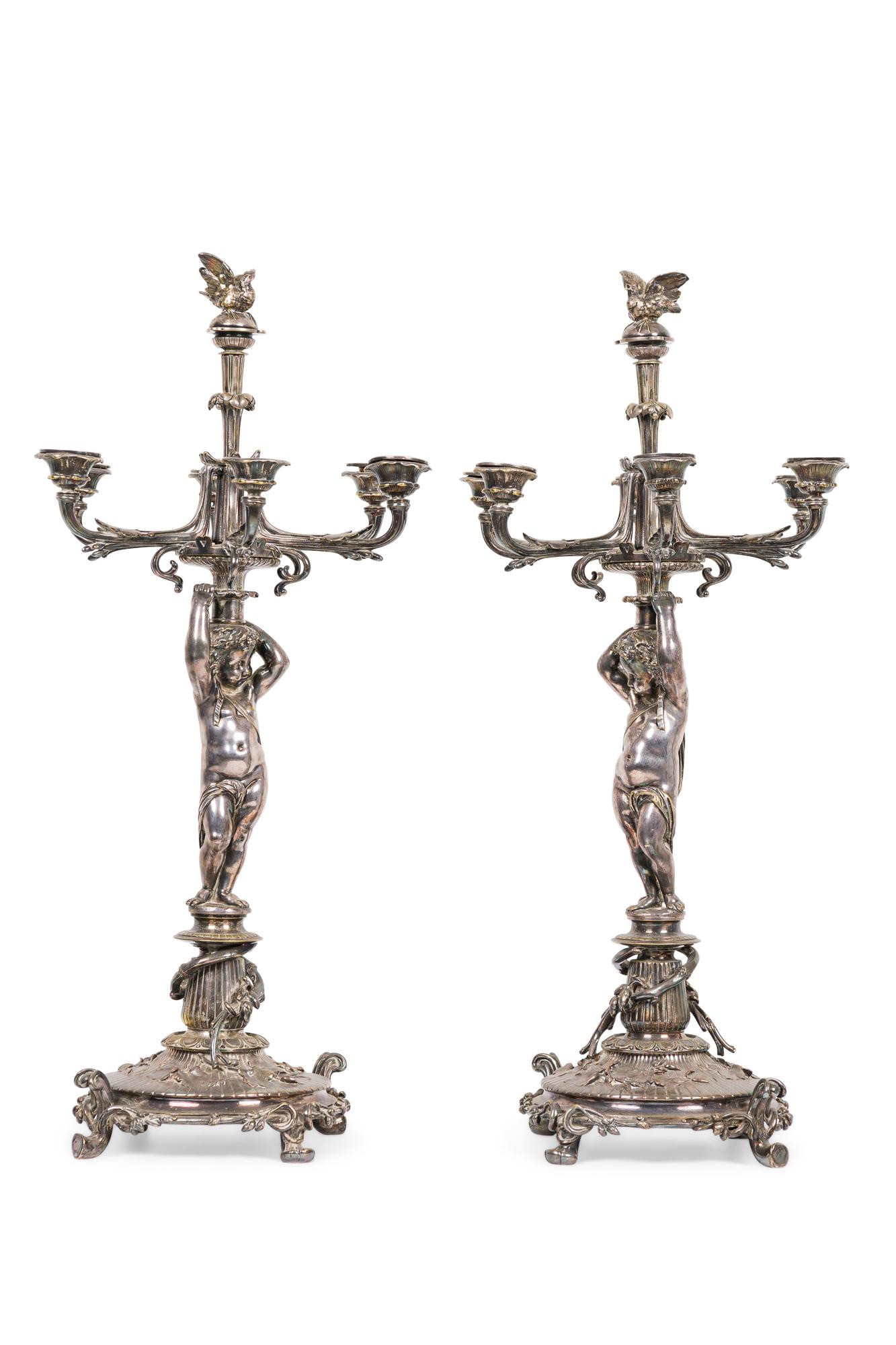 Pair of French Victorian silver plated candelabra with a cupid standing on a circular base and holding 6 branches (by CHRISTOFLE & CIE) (PRICED AS Pair)
