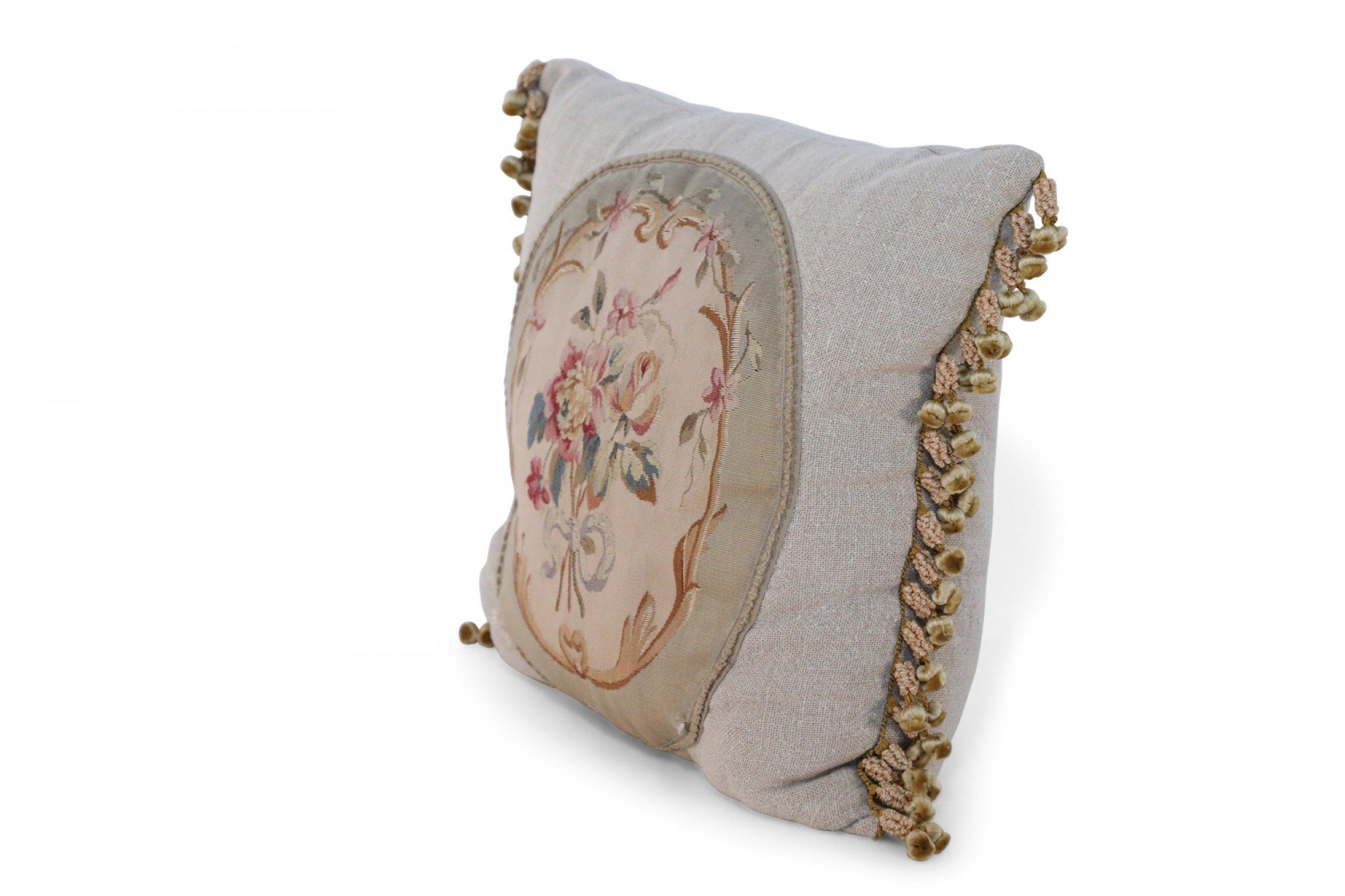 Pair of French Victorian square beige linen pillows with oval floral Aubusson centers and gold braided trims. (priced as pair).
       