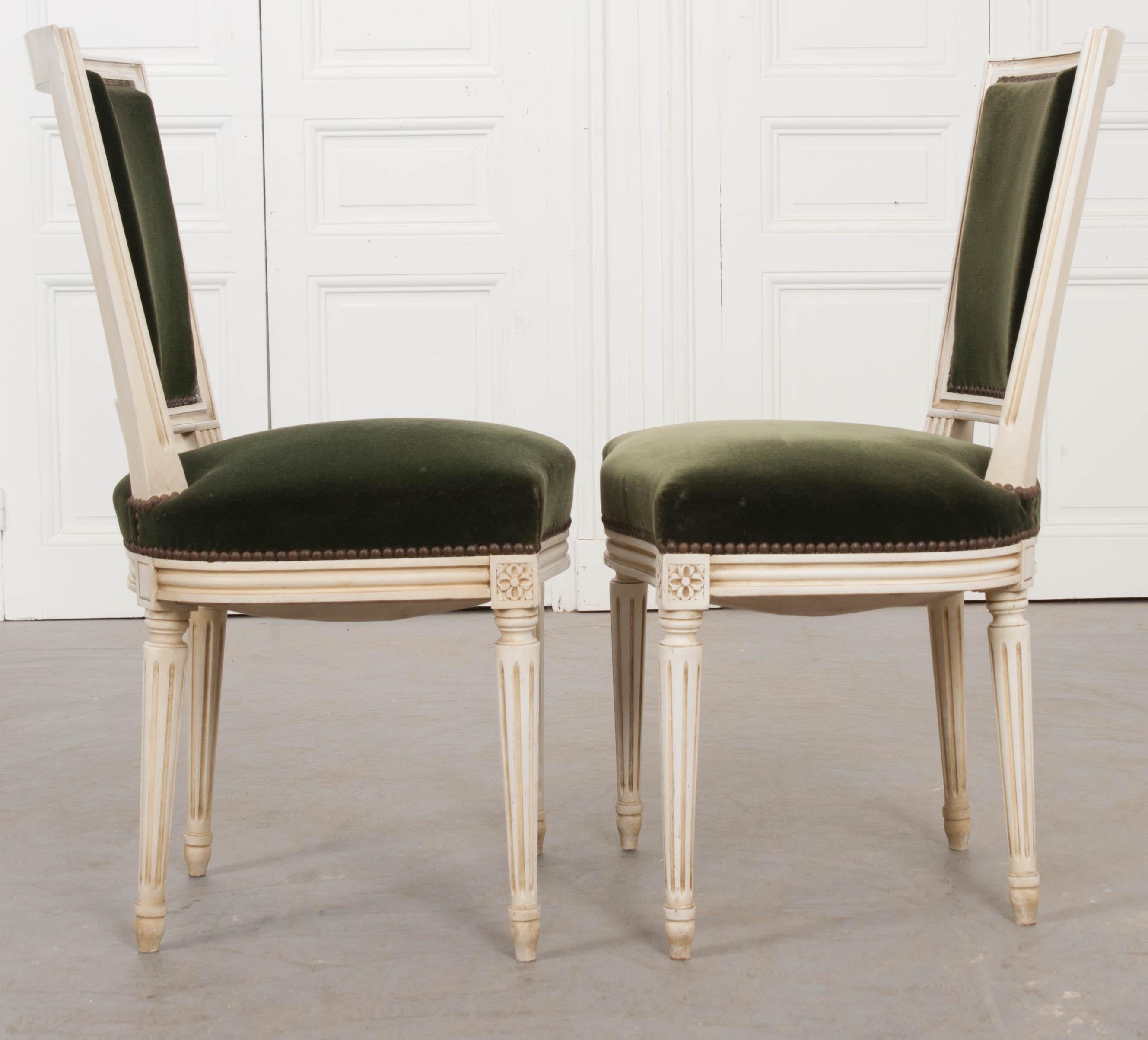 This charming pair of vintage Louis XVI cream-painted side chairs, circa 1970s, were found in France and are presented in their original green velvet upholstery.
