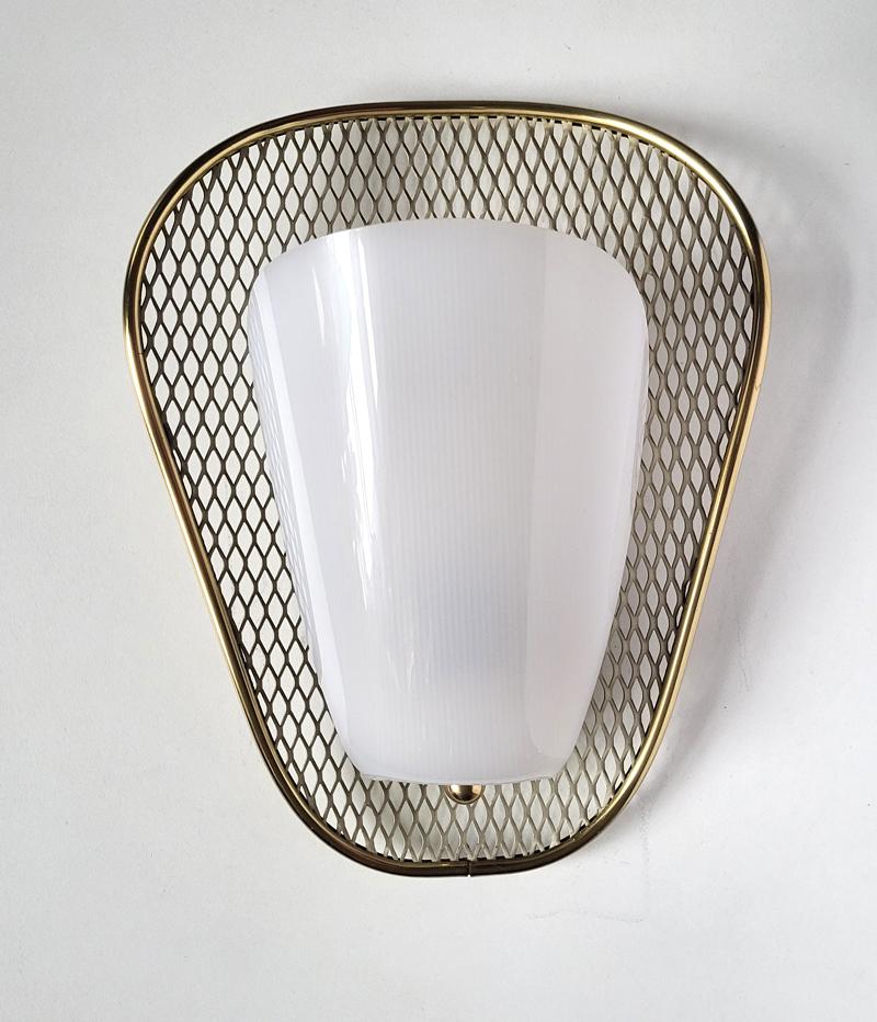 Lovely pair of midcentury Sconces attributed to Mathieu Matégot.
France, 1950s.
Perforated, enameled metal shield with brass and lucite.
Lamp sockets: 1.