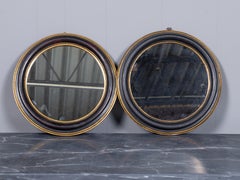 Pair of French Vintage Round Ebonized and Giltwood Mirrors