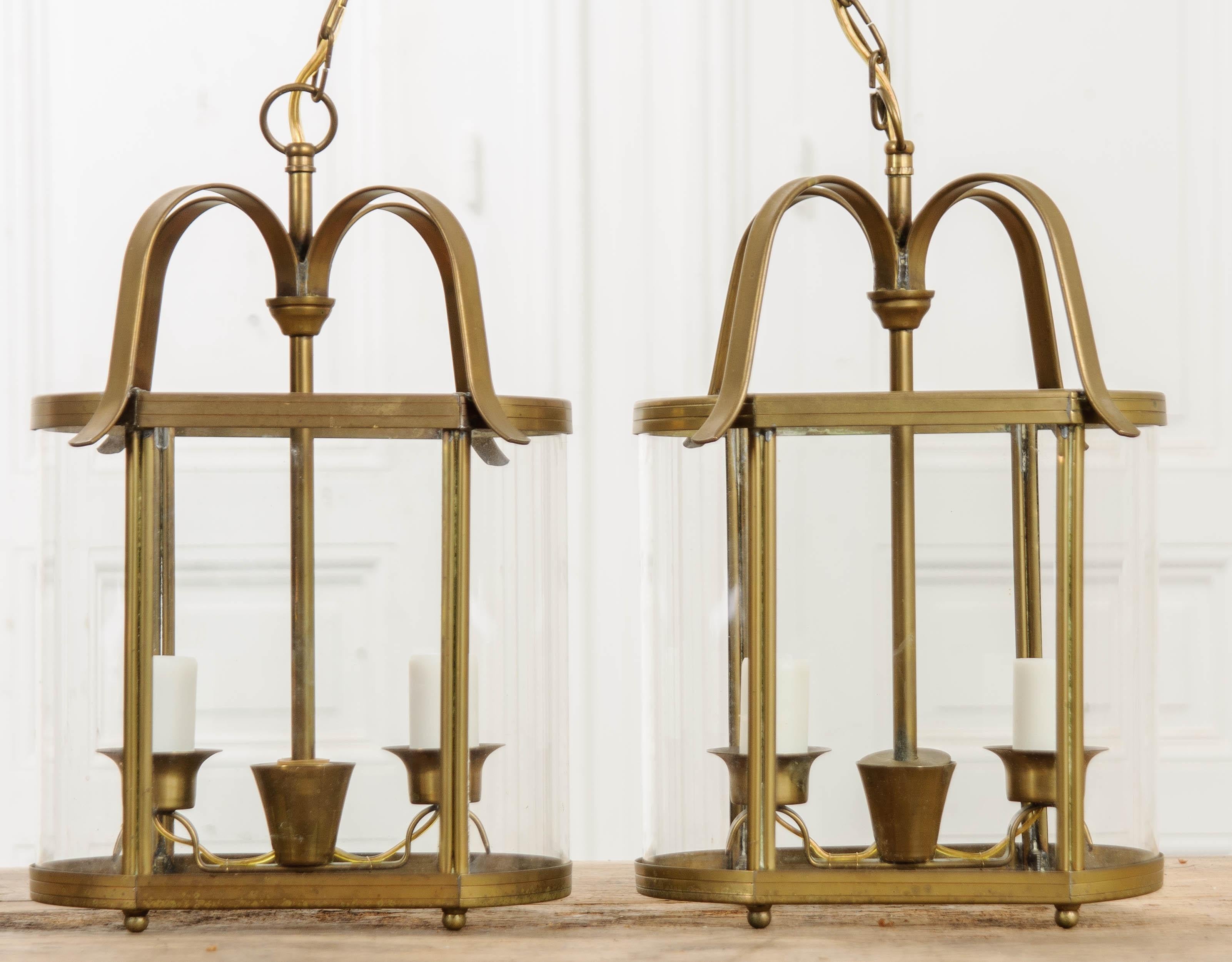 This darling pair of brass lanterns comes from early 20th century France. The fixtures have a simple, yet elegant design, making their appeal universal. They would make exceptional additions to a foyer or entry, bathroom, breakfast/reading nook,