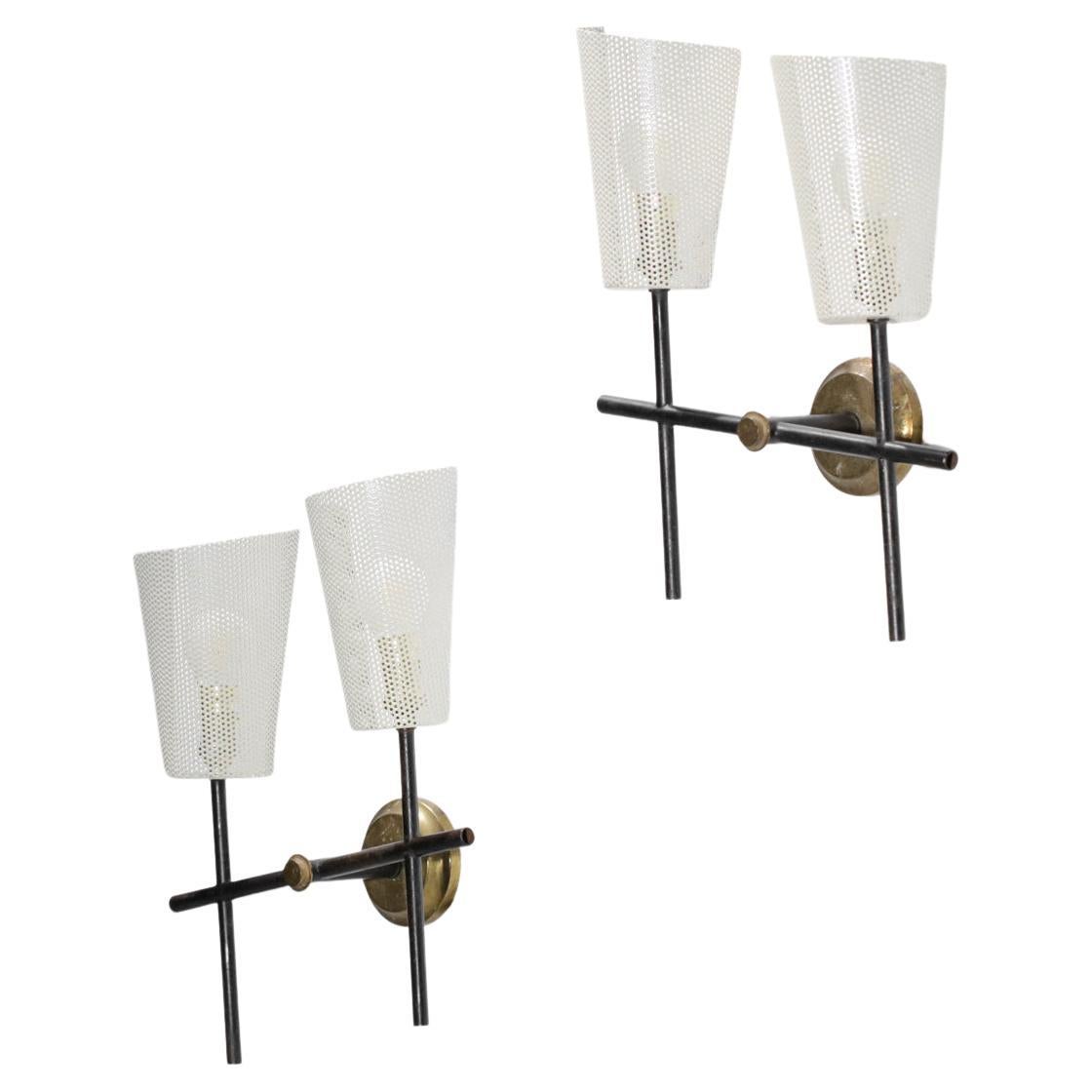 Pair of French sconces from the 50's in the style of Mathieu Matégot's work. Black lacquered metal structure and solid brass wall plate. Lampshade in perforated sheet metal or rigitulle repainted in beige. Nice vintage condition, please note the