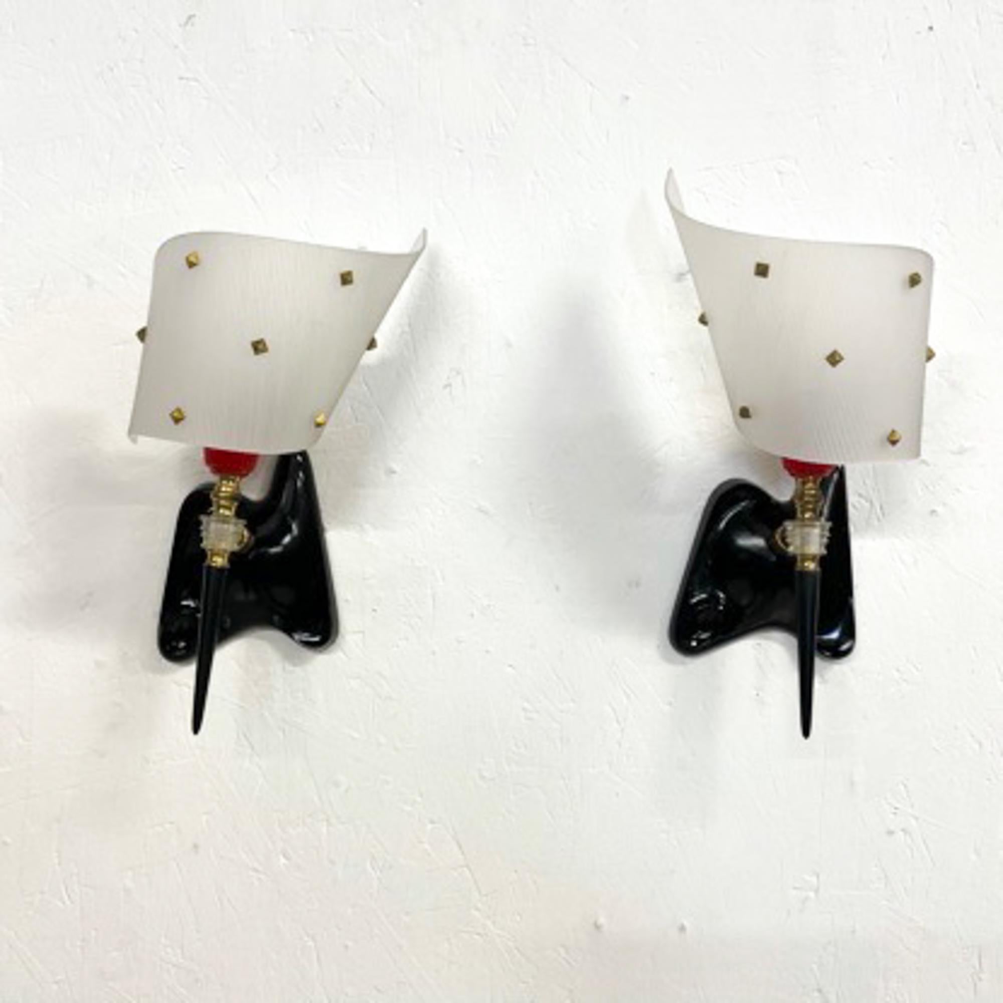 For your consideration a pair of French wall sconces. Sculptural shape with black wall mount and plexiglass-plastic curved shades in white opaline color (translucent). The shades are decorated with brass diamond shape studs. 

Made in France Circa