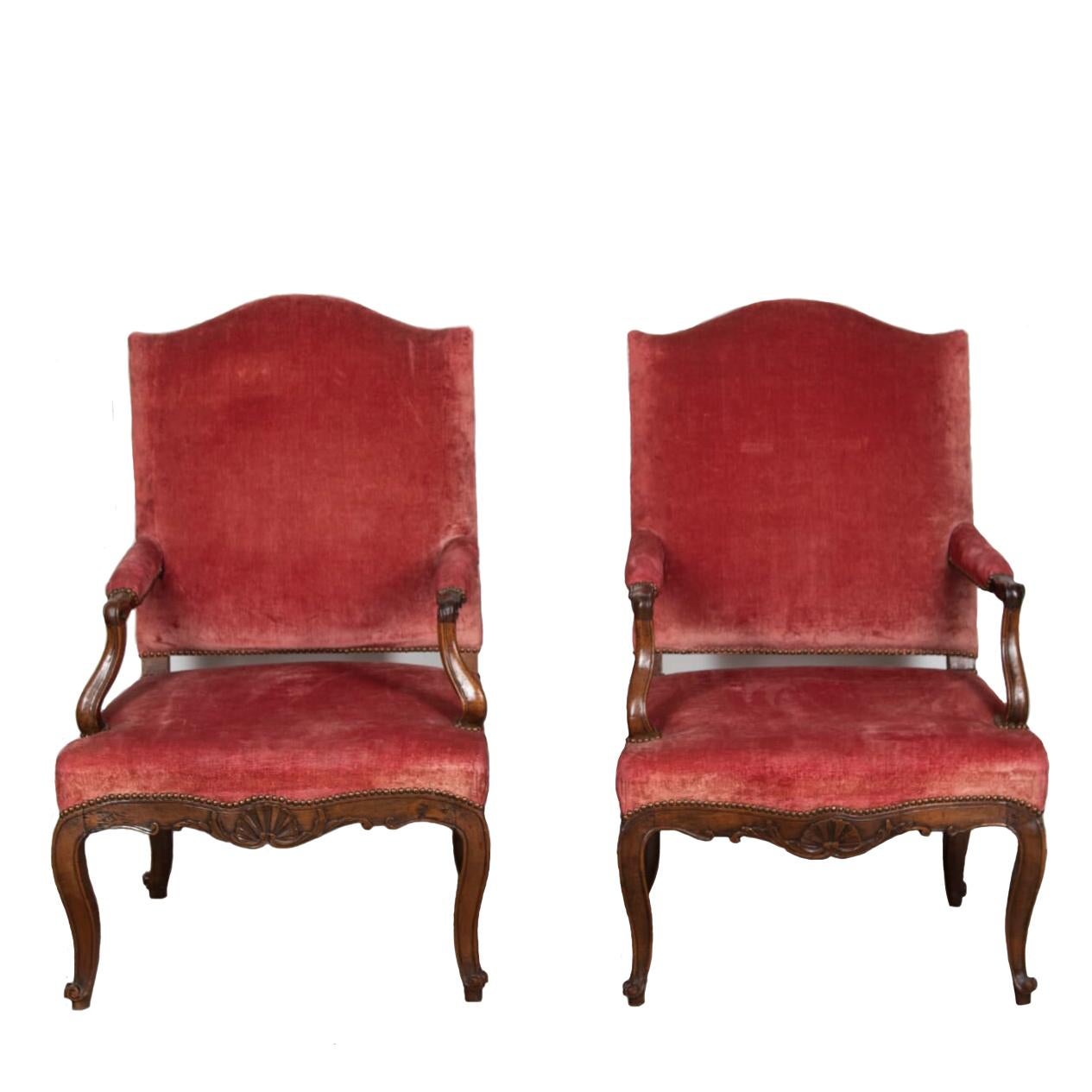 Large pair of mid 18th Century Louis XV walnut open armchairs.

Finely carved with shell motifs and leaf decoration to the front apron and further undulating side rails. The wide seat sits on shapely cabriole legs ending in beautifully carved