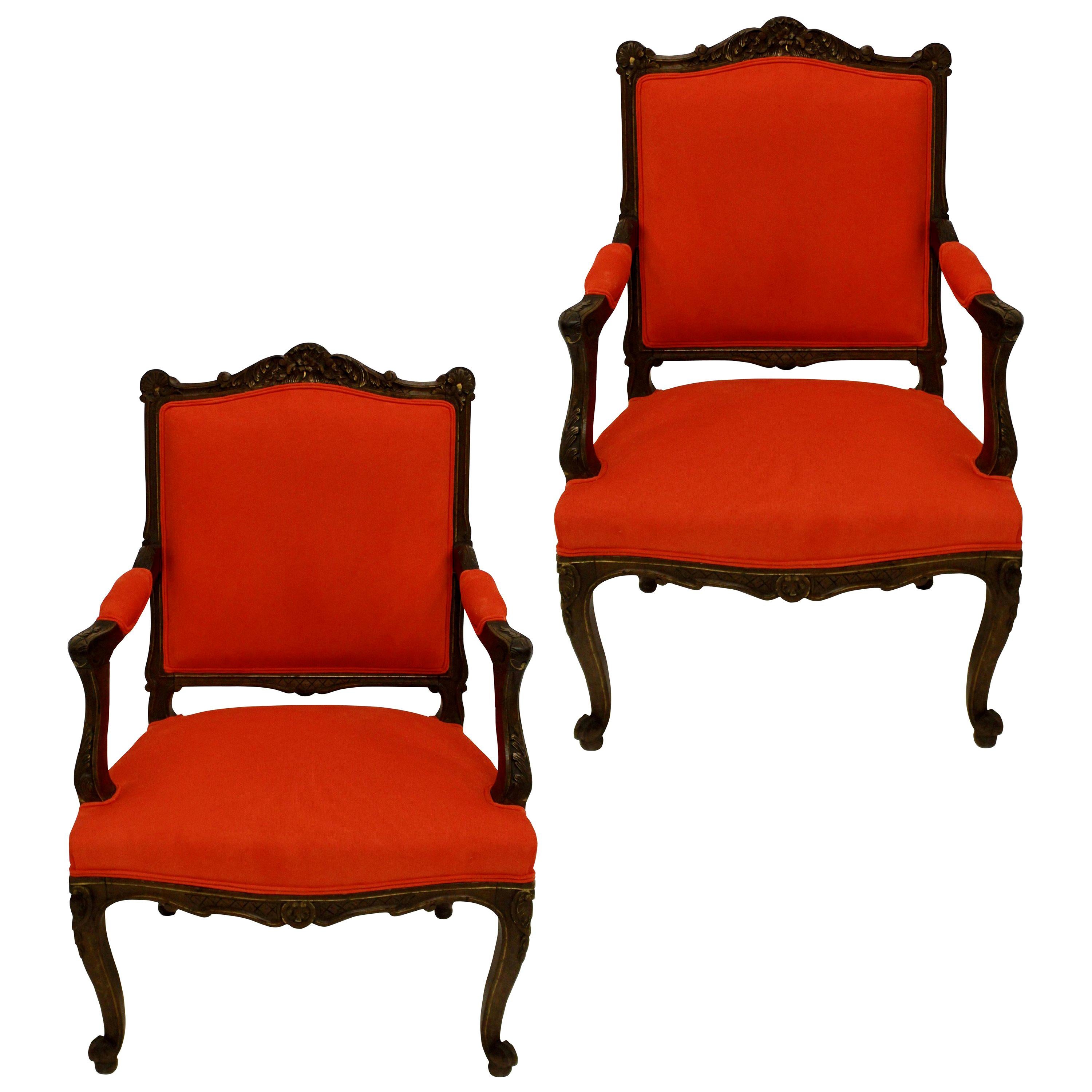 A pair of French Louis XV style walnut armchairs, beautifully carved with highlighted gilding in places, newly upholstered in blood orange corduroy.

 