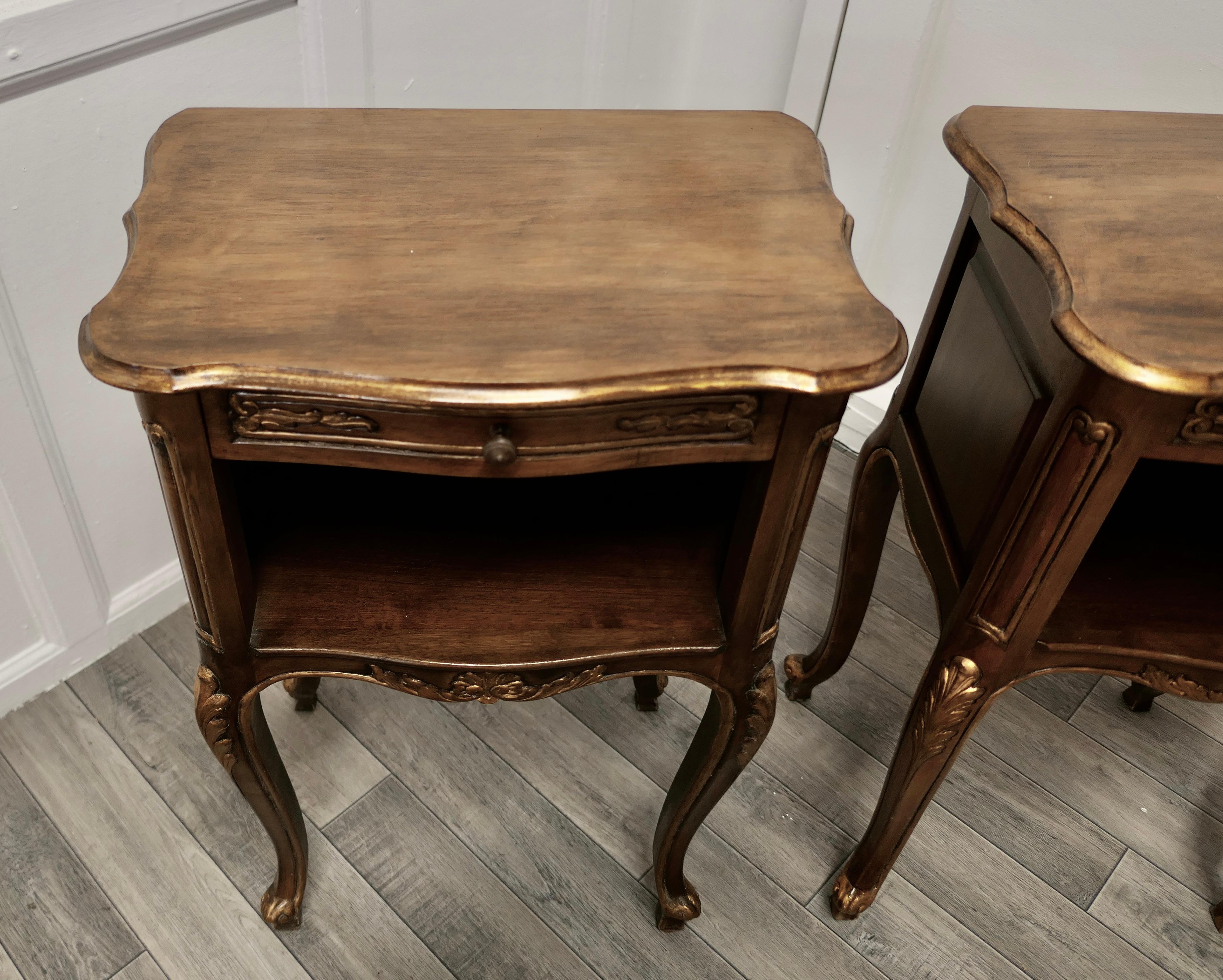 Pair of French Walnut Gilt Bedside Cabinets 

This is a pretty pair of cabinets or chevets, they are made in Walnut and have a shaped top with an open book shelf and a drawer standing on slim cabriole legs
The cabinets are decorated in the rococo