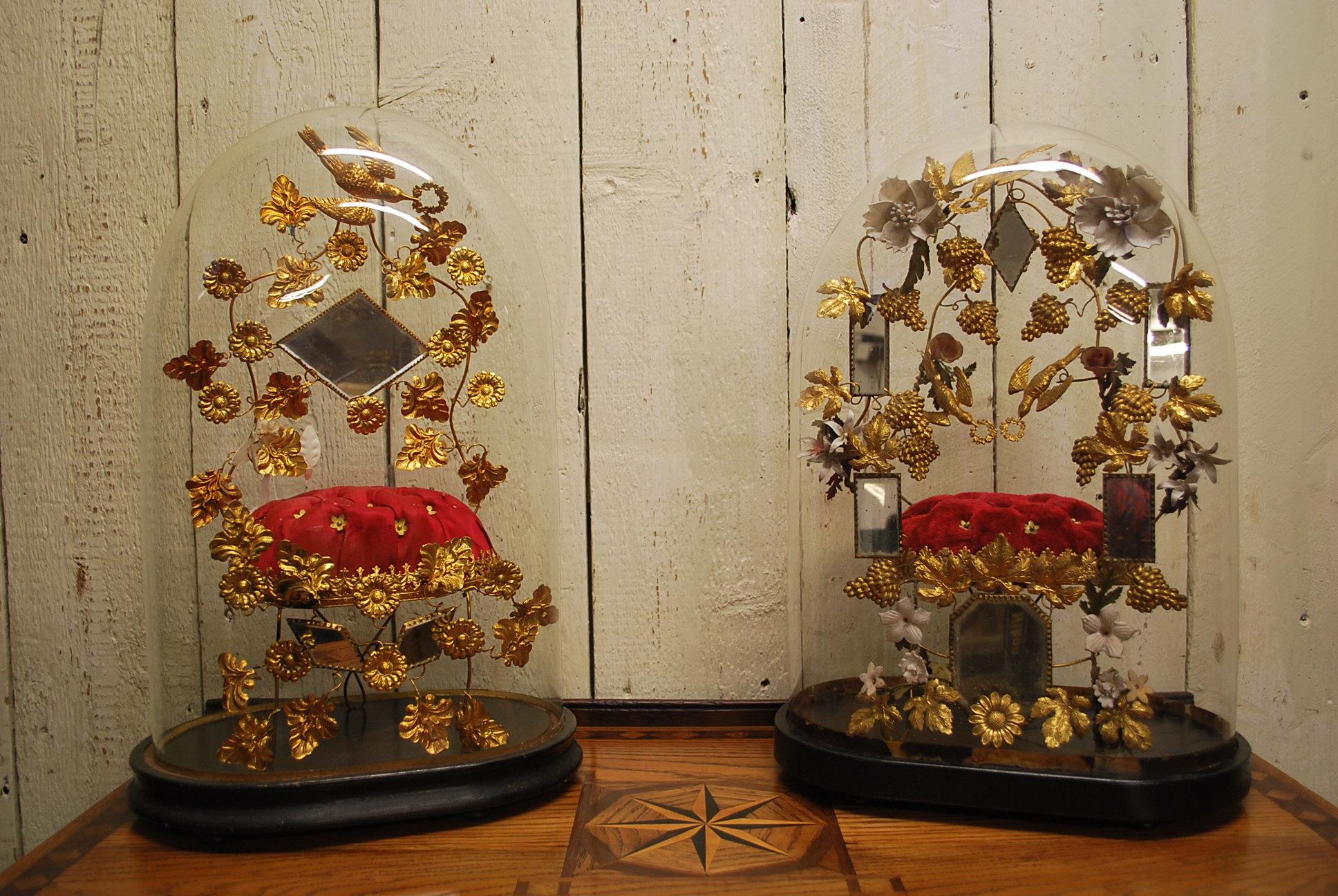 Hutton-Clarke Antiques is delighted to present an exquisite pair of French wedding displays, elegantly showcased within their original, generously sized glass domes. Adorned with intricate gilt foliage, faceted mirrors, and sumptuous deep buttoned