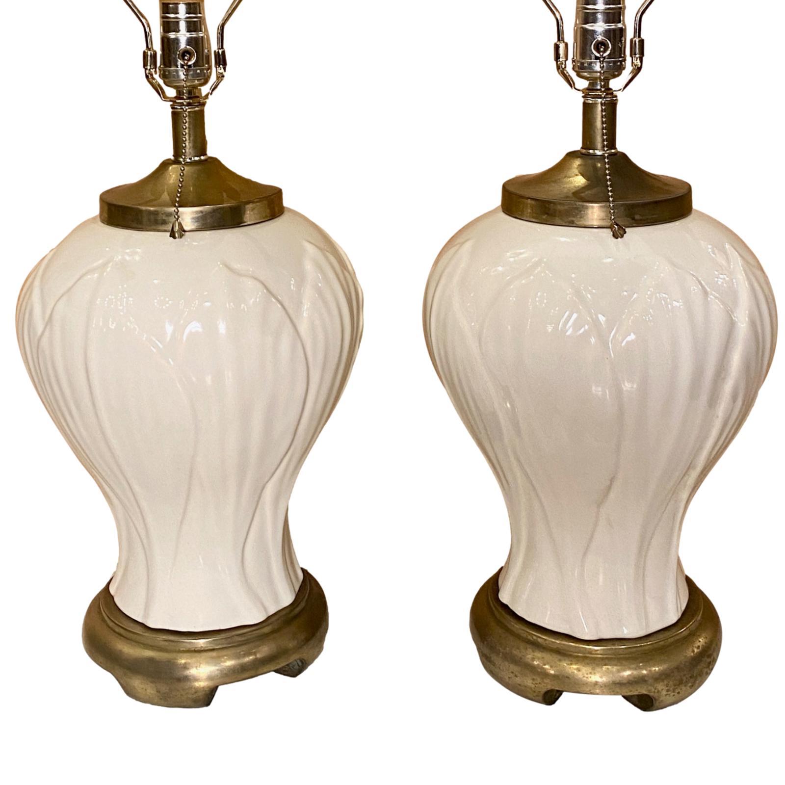 Pair of circa 1940's French porcelain lamps with leaf pattern on body and metal bases.

Measurements:
Height of body: 16